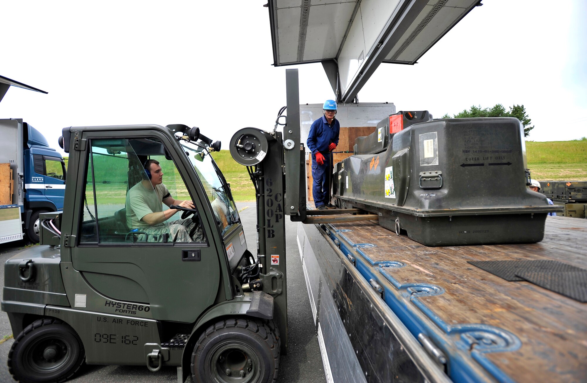 MISAWA AIR BASE, Japan -- Senior Airman Derek White, 35th Maintenance Squadron munitions systems specialist, loads munitions on to a flatbed truck July 13. The 35th Maintenance Squadron teamed up with the 35th Logistics Readiness Squadron to complete this movement. (U.S. Air Force photo/Staff Sgt. Chad C. Strohmeyer)