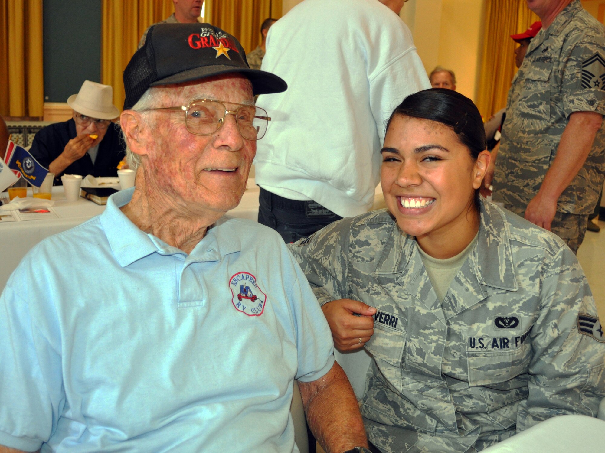 TRAVIS AIR FORCE BASE, Calif. -- Reservist Senior Amn Vanessa Echeverri, 349th Civil Engineer Squadron operations, shares her beautiful smile with a veteran at the California Veterans Home,Yountville.  The 10th anniversary of "Operation Gratitude" was a day of caring and sharing for the 349th Air Mobility Wing Airmen. At the largest veterans home in the state of California, the Travis Airmen threw a champagne brunch for the veterans who paved the way for those of us who still serve. The morning festivities included the Airmen preparing and serving the brunch, and visiting with the veterans in the hospital complex. The festivities included ceremony, music and more. For the complete story, see the August issue of The Contact magazine. (U.S. Air Force photo/Senior Master Sgt. Ellen L. Hatfield)