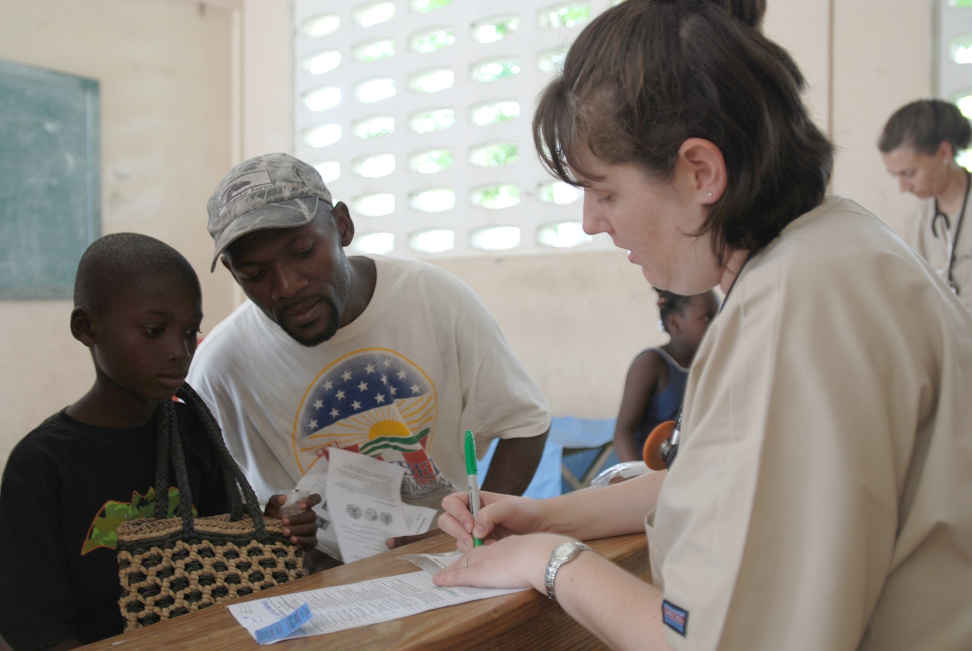 Maj. Teresa Stump gives patients instructions on how to take their medication at the U.S. Army South New Horizons-Haiti 2010 Ennery medical assistance site July 13, 2010, in Mandrin, Haiti. Major Stump is a physician with the 56th Medical Group. (U.S. Army Photo/Spc. Jessica M. Lopez)