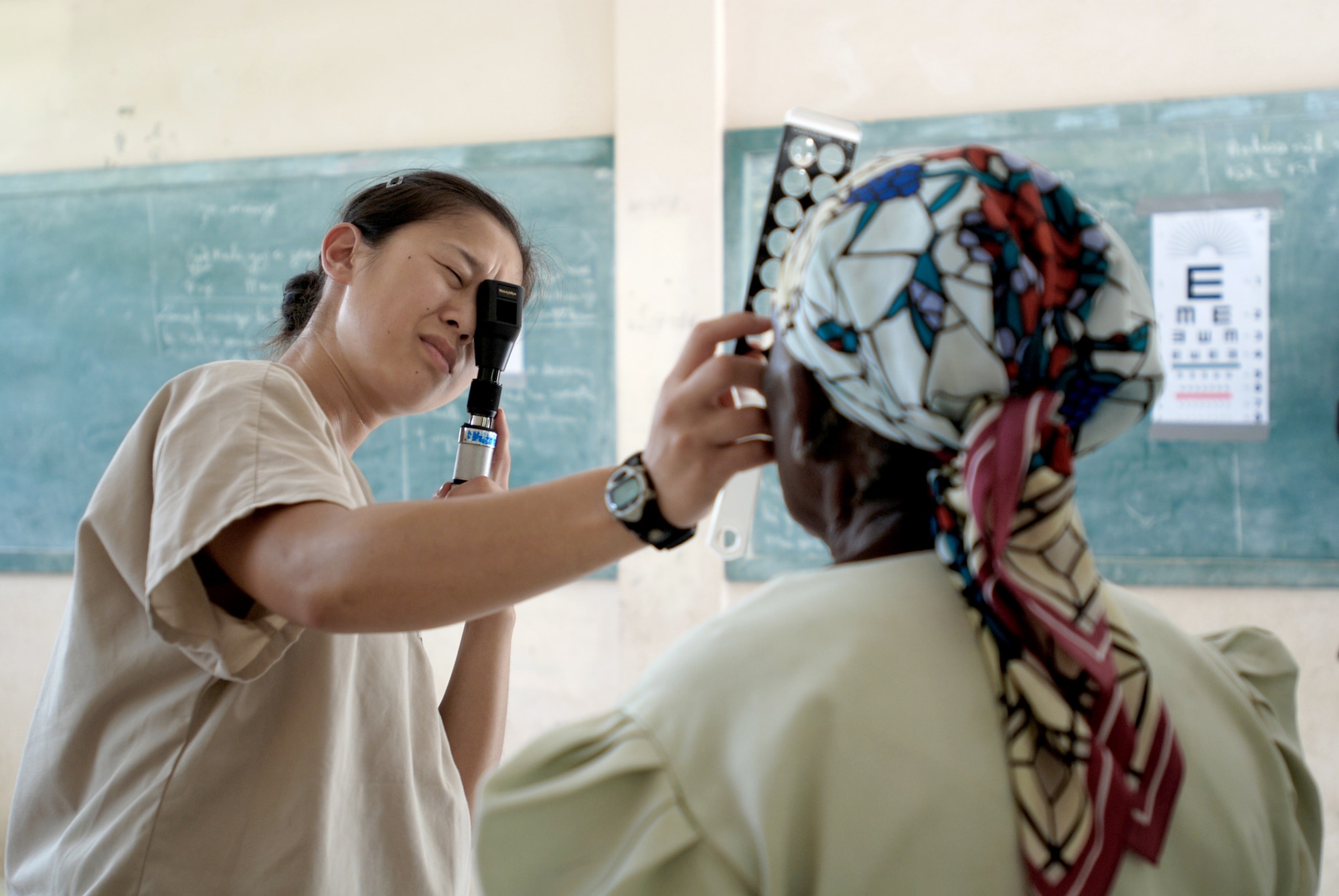Capt. Ivy Madson conducts an eye exam for a patient at the U.S. Army South New Horizons-Haiti 2010 Ennery medical assistance site July 13, 2010, in Mandrin, Haiti. Captain Madson is an optometrist with the 56th Medical Group. (U.S. Army photo/Spc. Jessica M. Lopez)