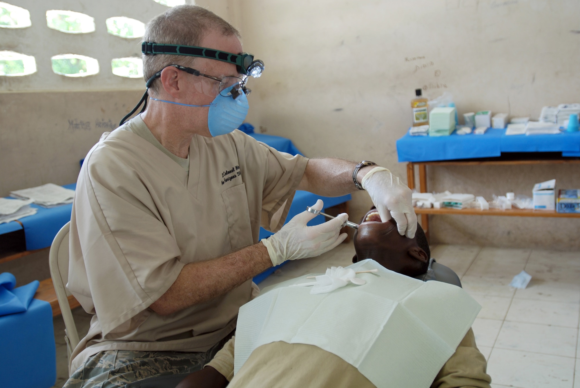 Lt. Col. Richard Moore prepares a patient for a tooth extraction at the U.S. Army South New Horizons-Haiti 2010 Ennery medical assistance site July 13, 2010, in Mandrin, Haiti. New Horizons officials, in partnership with officials from the government of Haiti, are conducting various medical, dental and engineering missions for people in Gonaives, Haiti. Colonel Moore is a dentist with the 56th Medical Group. (U.S. Army photo/Spc. Jessica M. Lopez)