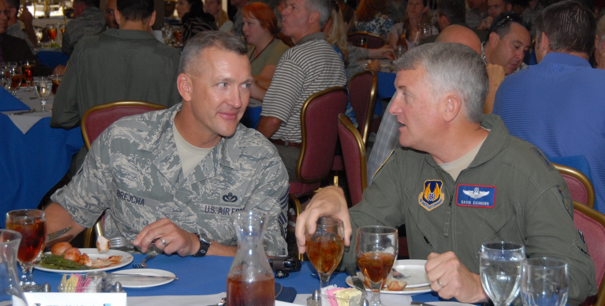 Chief Master Sgt. Mark S. Brejcha, 412th Test Wing command chief, and Maj. Gen. David J. Eichhorn, Air Force Flight Test Center commander, sit at the Chief's retirement luncheon July 14 at Club Muroc.  (Air Force photo by Kenji Thuloweit)