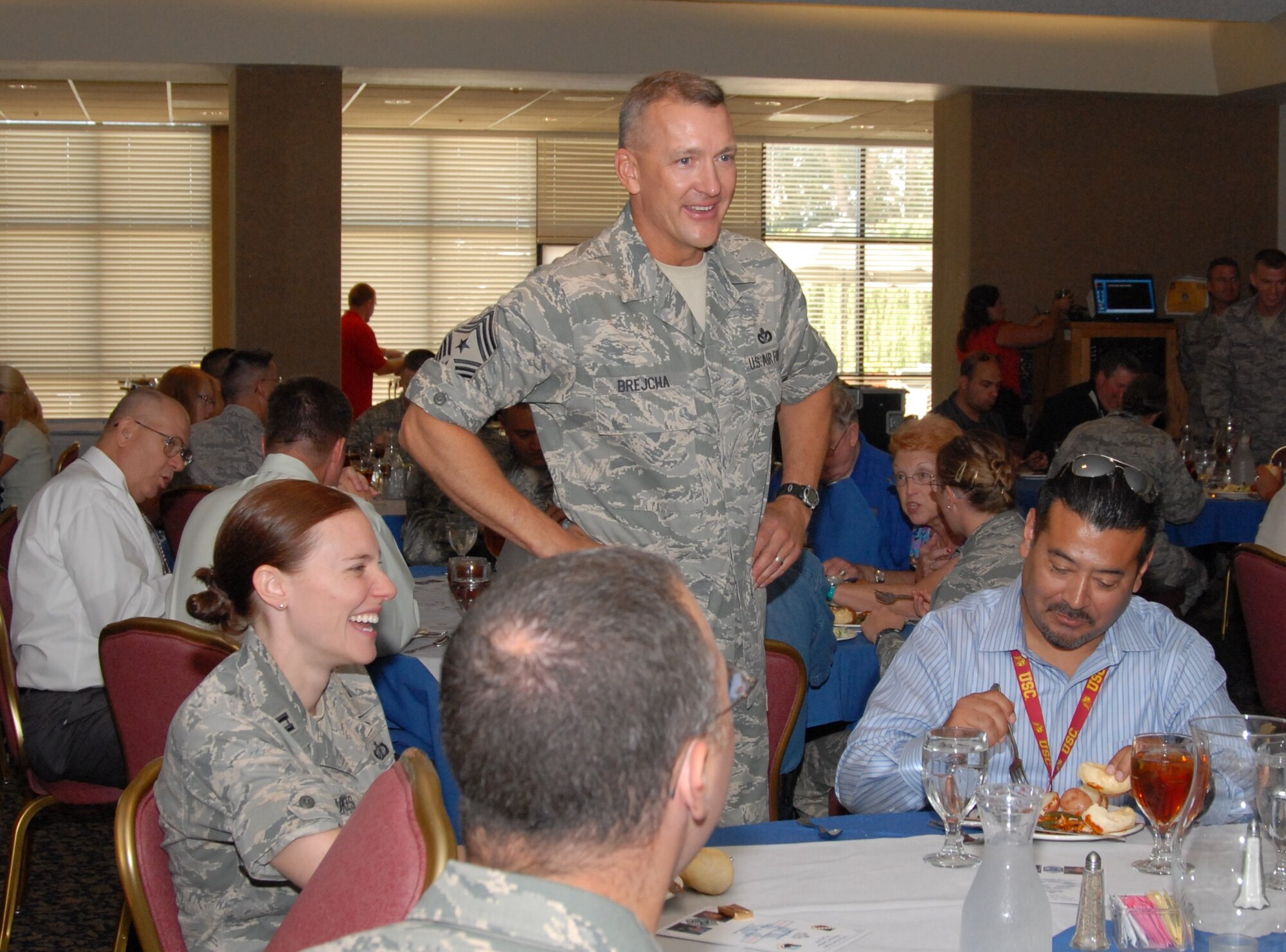 Chief Master Sgt. Mark S. Brejcha makes the rounds at his retirement luncheon July 14 at Club Muroc.  Chief Brejcha relinquished his responsibilities as 412th Test Wing command chief at his retirement ceremony July 16.  He retired with nearly 30 years of active duty service.  (Air Force photo by Kenji Thuloweit)
