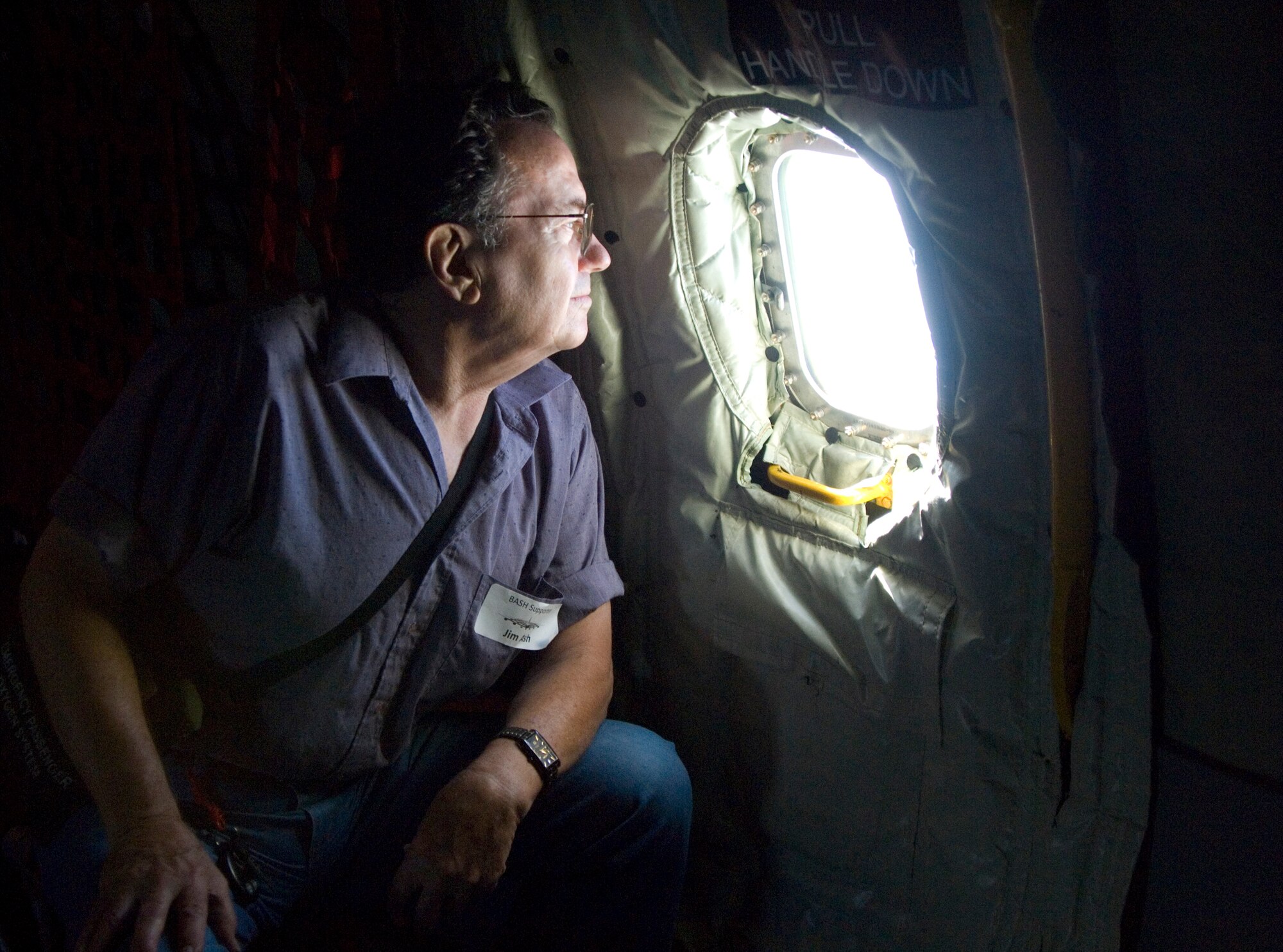 Jim Ash, McConnell neighboring landowner, views the Kansas landscape from a window in a KC-135 Stratotanker during the Landowner’s Appreciation Flight July 9, 2010.  Seventeen local landowners participated in the flight which displayed McConnell’s appreciation for the landowner’s cooperation in the Bird Aircraft Strike Hazard program.  (U.S. Air Force photo/Senior Airman Abigail Klein)
