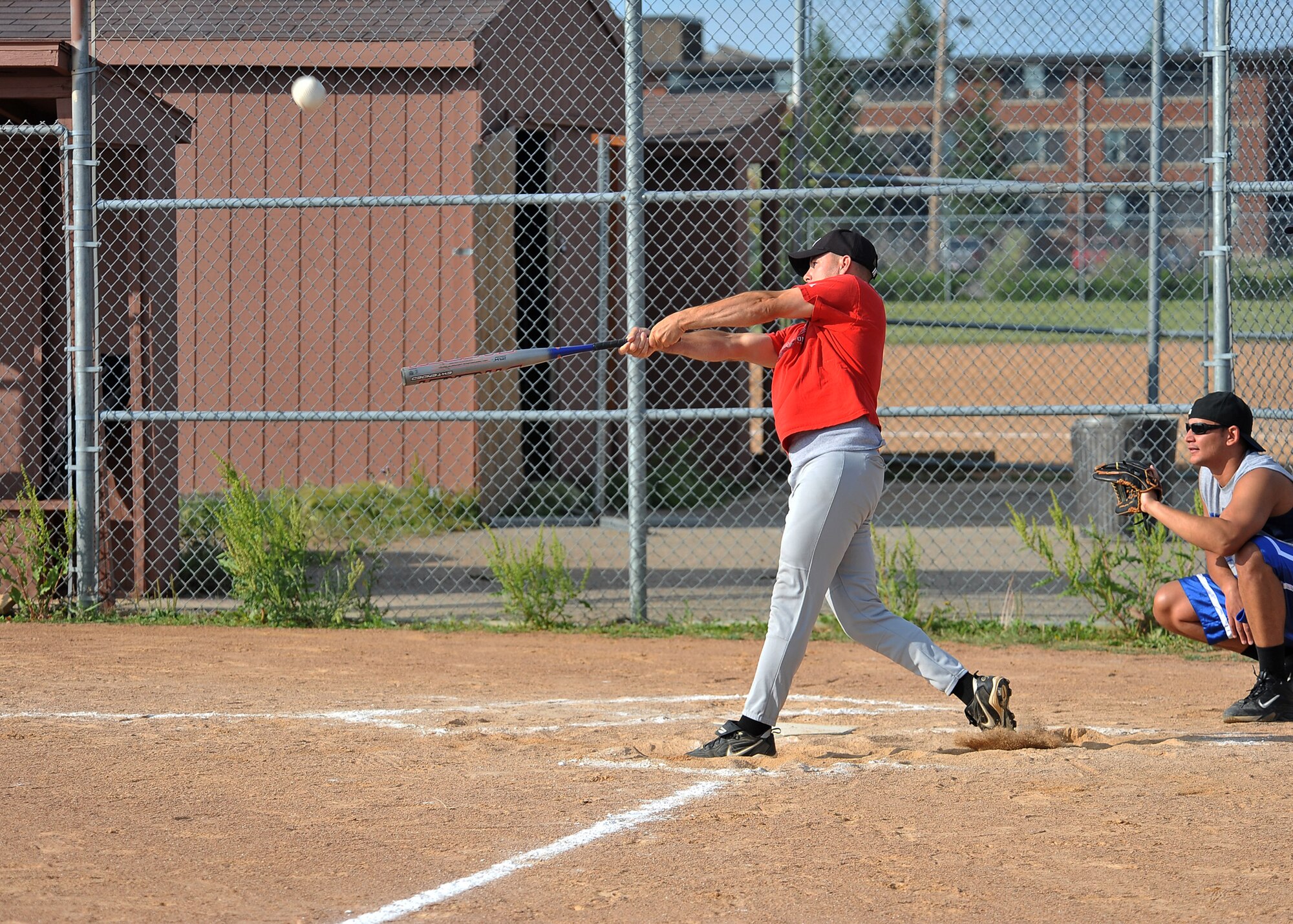 MINOT AIR FORCE BASE, N.D. -- Tech. Sgt. Paul Nixon, Minot AFB Honor Guard noncommissioned office-in-charge, hits an incoming pitch during a softball game against the 5th Operations Group here July 12. The 5th OG trumped the 5th Bomb Wing staff team 15-11. (U.S. Air Force photo by Senior Airman Michael J. Veloz)
