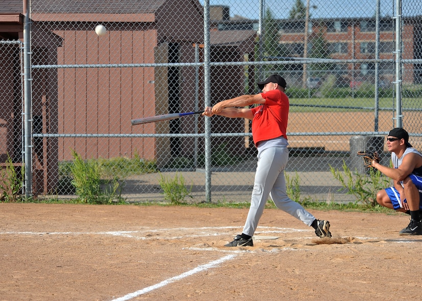 MINOT AIR FORCE BASE, N.D. -- Tech. Sgt. Paul Nixon, Minot AFB Honor Guard noncommissioned office-in-charge, hits an incoming pitch during a softball game against the 5th Operations Group here July 12. The 5th OG trumped the 5th Bomb Wing staff team 15-11. (U.S. Air Force photo by Senior Airman Michael J. Veloz)