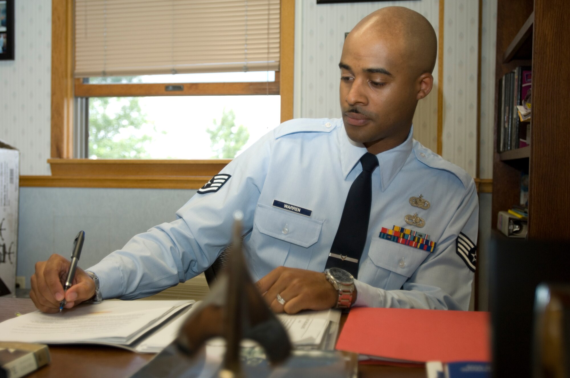 Staff Sgt. Bryant Warren, 22nd Air Refueling Wing Equal Opportunity NCOIC, reviews an equal opportunity report July 12, 2010, McConnell Air Force Base. In addition to his normal duties, Sergeant Warren is also the unit fitness manager for the wing staff agencies. (U.S. Air Force photo/Airman 1st Class Armando A. Schwier-Morales)
