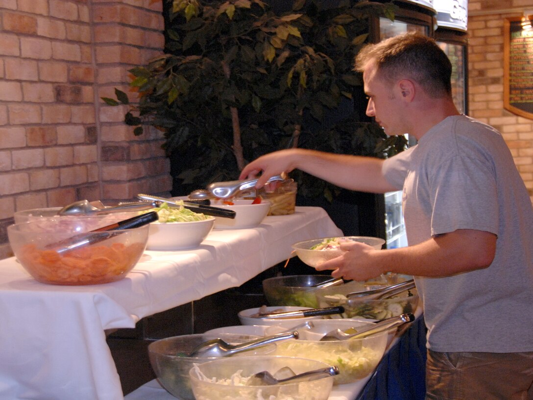 ANDERSEN AIR FORCE BASE, Guam - Civilians and servicemembers participate in Mongolian Night at the Top of the Rock's Cafe Latte July 7. Cafe Latte also offers wing night and fajita night each week. (U.S. Air Force photo by Airman Whitney Amstutz)