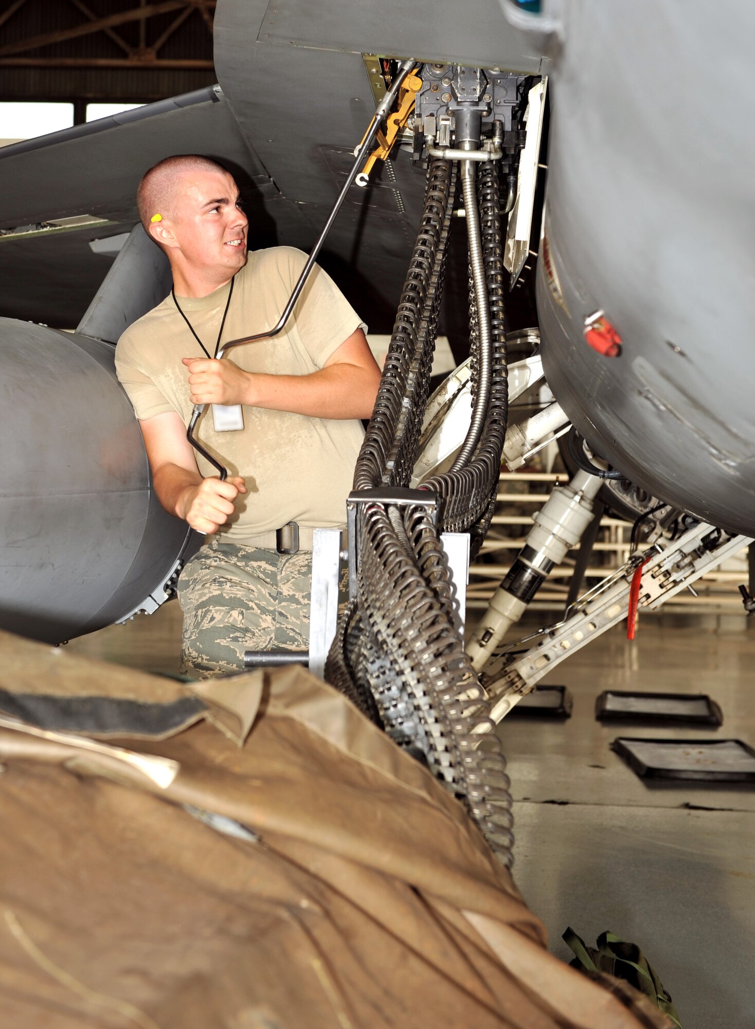 100709-F-4406D-049 SHAW AIR FORCE BASE, S.C.--    Airman 1st Class James Helmick from the 79th Aircraft Maintenance Unit "Tigers" loads the five hundred and ten rounds of 20mm ammunition to the F-16 fighter jet as a part of the Weapons Load Crew Competition in Hanger 611, July 9, 2010. In the second Weapons Load Crew of the Quarter competition this year, two crews competed to become eligible for the Load Crew of the Year and to showcase the Tech. Sgt. Charles D. Lockwood Memorial trophy. (U.S. Air Force photo/ Airman 1st Class Tabatha L. Duarte)