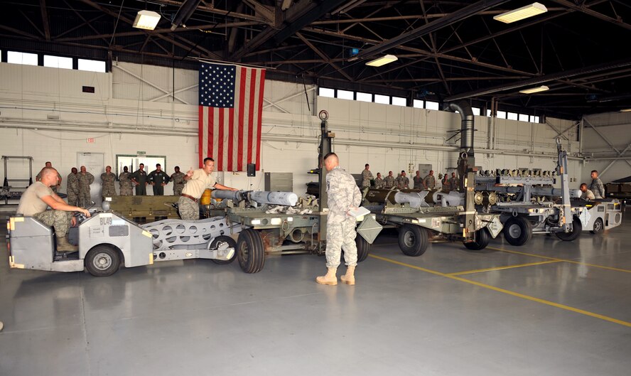 100709-F-4406D-039 SHAW AIR FORCE BASE, S.C.--    The 79th Aircraft Maintenance Unit "Tigers" team and the 77th Aircraft Maintenance Unit "Gamblers" both use bomb lift trucks to lift the air-intercept missiles for the Weapons Load Crew Competition in Hanger 611, July 9, 2010. In the second Weapons Load Crew of the Quarter competition this year, two crews competed to become eligible for the Load Crew of the Year and to showcase the Tech. Sgt. Charles D. Lockwood Memorial trophy. (U.S. Air Force photo/ Airman 1st Class Tabatha L. Duarte)