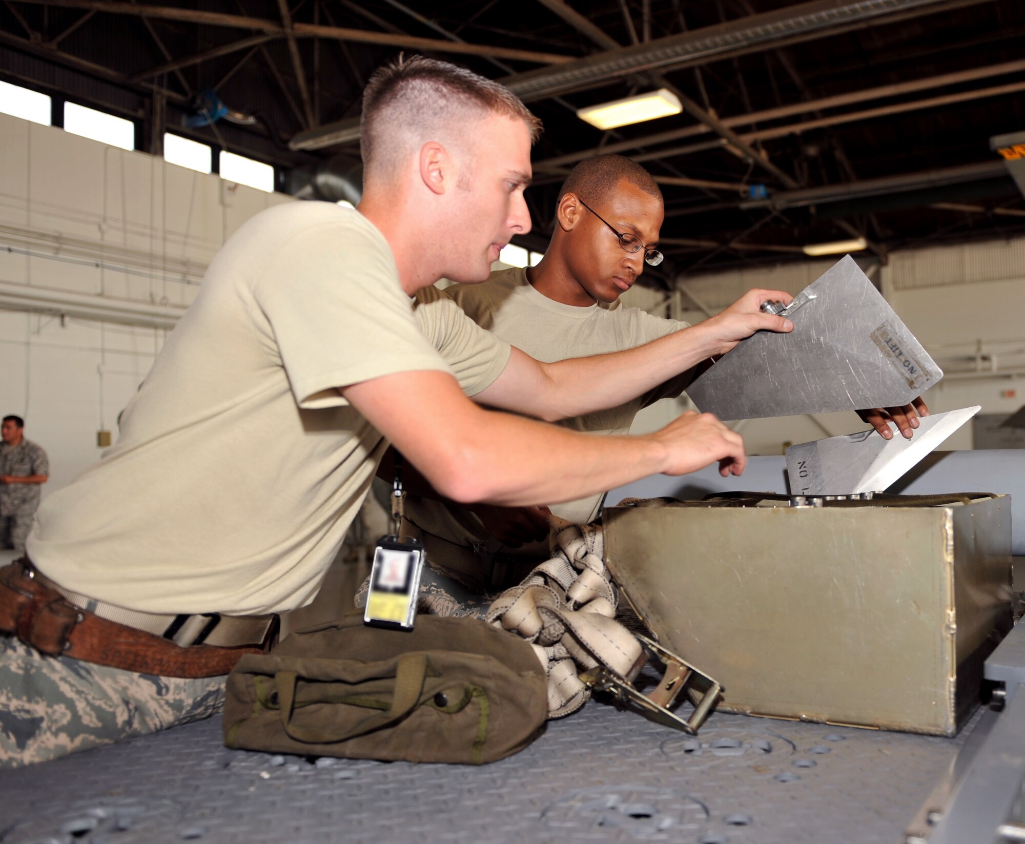 100709-F-4406D-015 SHAW AIR FORCE BASE, S.C.--    Staff Sgt. Michael Delucy and Airman 1st Class Marcus Mitchell from the 77th Aircraft Maintenance Unit "Gamblers" search for the necessary pieces needed for the air-intercept missiles during the Weapons Load Crew Competition in Hanger 611, July 9, 2010. In the second Weapons Load Crew of the Quarter competition this year, two crews competed to become eligible for the Load Crew of the Year and to showcase the Tech. Sgt. Charles D. Lockwood Memorial trophy. (U.S. Air Force photo/ Airman 1st Class Tabatha L. Duarte)