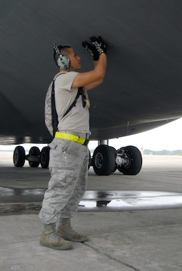 Staff Sgt. Daniel Chin, 43rd Aircraft Maintenance Squadron, closes the external power latch on a C-5 aircraft on the Pope flightline, July 13. Sergeant Chin is an aerospace propulsion mechanic for C-5 and C-17s. (U.S. Air Force Photo/1st Lt. Cammie Quinn) 