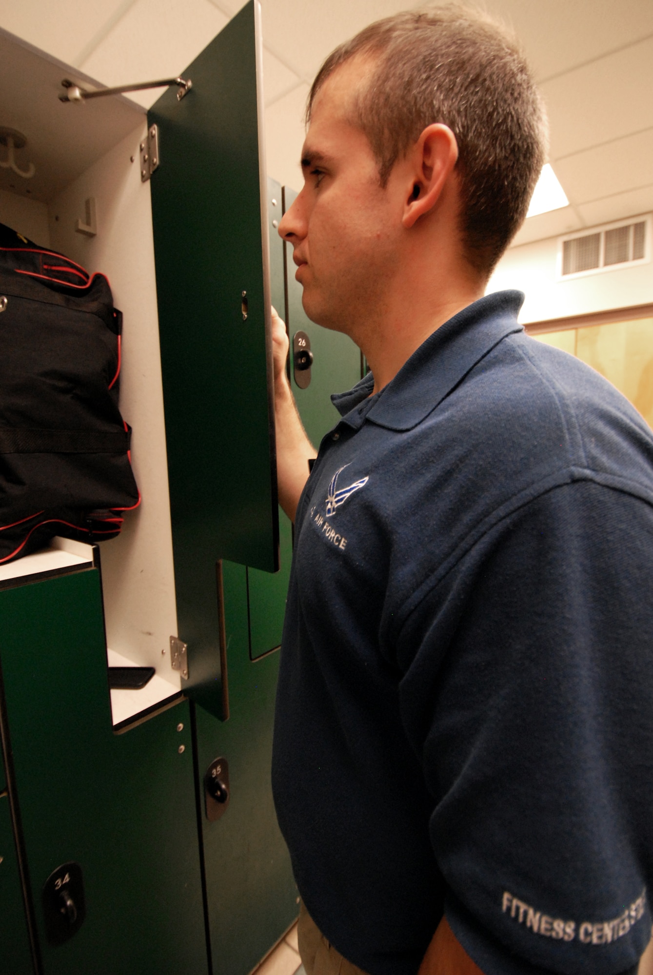 Senior Airman Aaron Spencer, 96th Force Support Squadron, finds some personal property unsecured in the locker room at the base fitness center July 14 at Eglin Air Force Base, Fla.  There has been significant increase in thefts at and around the fitness center in the past few months, according to 96th Security Forces Squadron.  Due to this, FSS is taking steps to make the fitness center more secure.  Beginning, July 19, the fitness center will become a single-point entry facility.  The entry/exit point will be the entrance facing the Eglin enlisted club.  In the meantime, the fitness center staff has stepped up by patrolling the locker room areas, parking lots and random ID checks.  (U.S. Air Force photo/Samuel King Jr.)