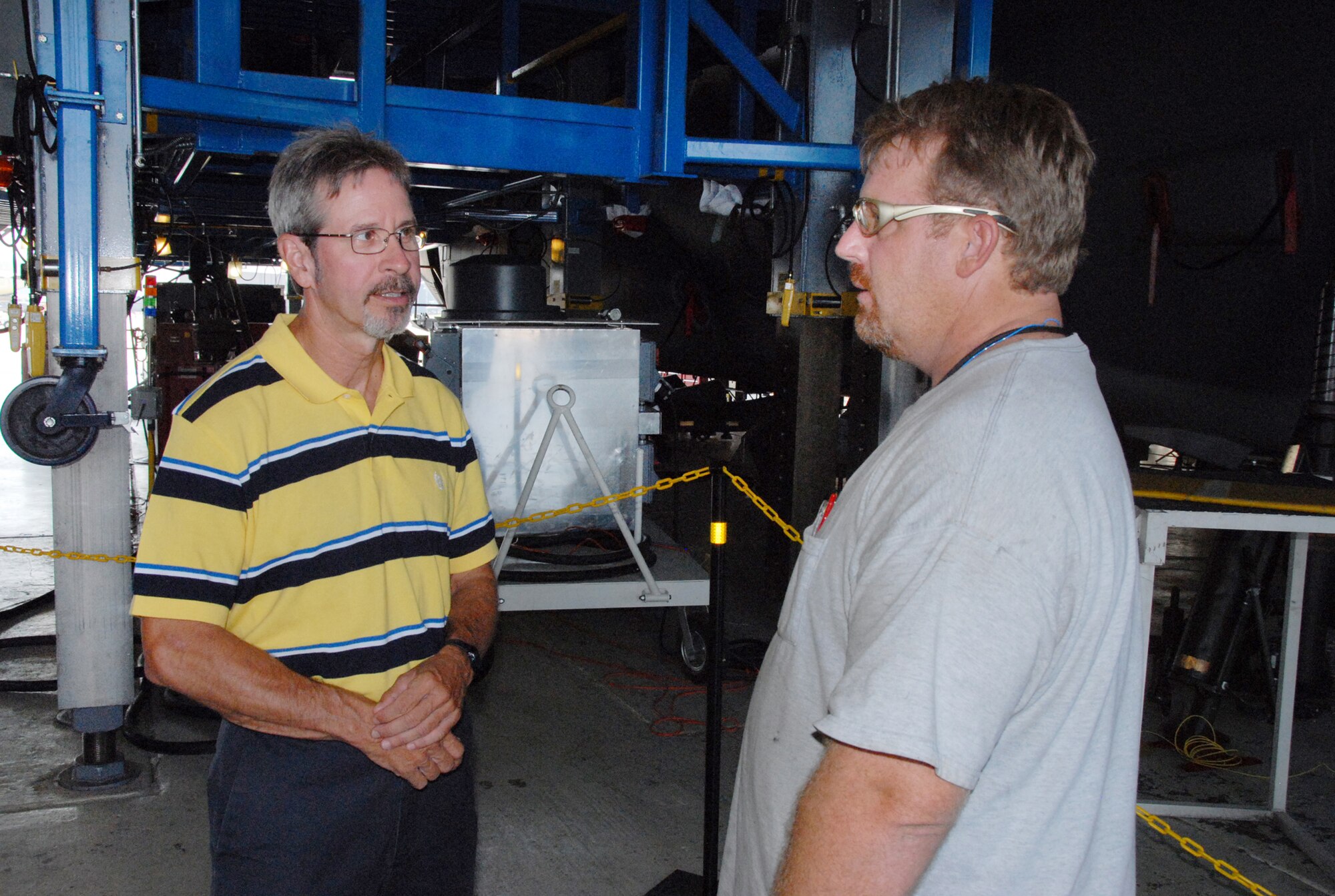 Doug Keene, left, and Bryce Padgett, discuss the latest HVM C-130. U. S. Air Force photo by Wayne Crenshaw