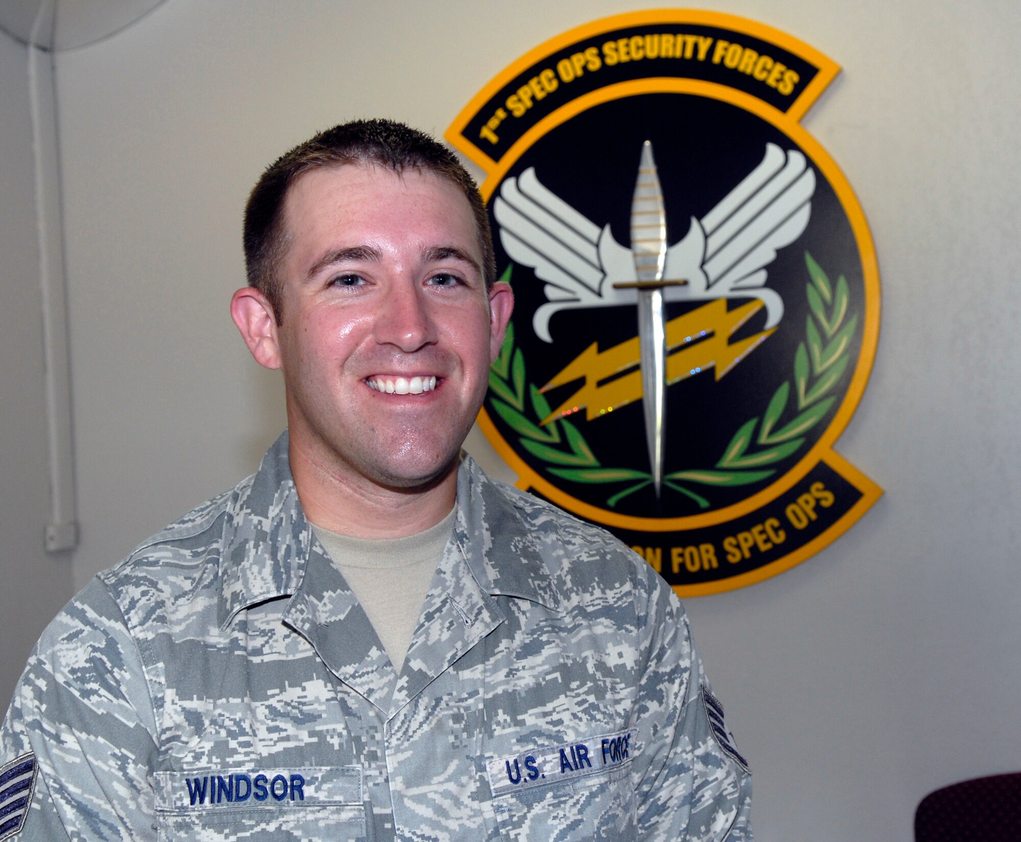 Staff Sgt. Joshua Windsor, 1st Special Operations Security Forces Squadron pass and registration NCO-in-charge, poses in front of the 1st SOSFS logo at his squadron's building at Hurlburt Field, Fla., July 14, 2010. Sergeant Windsor was selected for this week's "Tip of the Spear" spotlight. (DoD photo by U.S. Air Force Airman 1st Class Joe McFadden/RELEASED) 