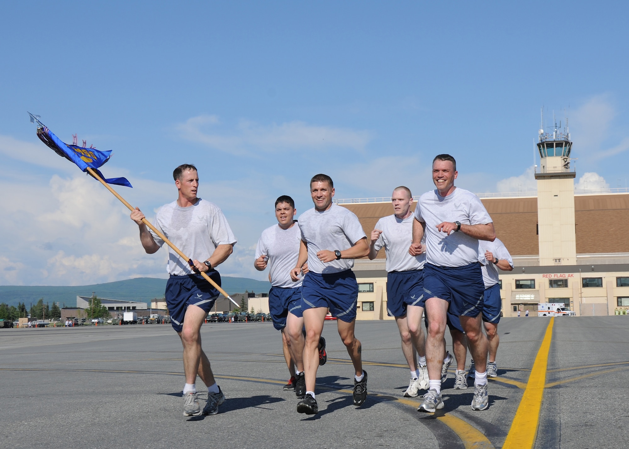 Airmen of the 354th Civil Engineering Squadron participate in a wing run on the flightline on July 2, 2010, Eielson Air Force Base, Alaska.  Due to the harsh winters in Alaska, most Eielson Airmen are only able to perform physical fitness outside from May through August.  (U.S. Air Force photo/Staff Sgt. Tia Wilson)