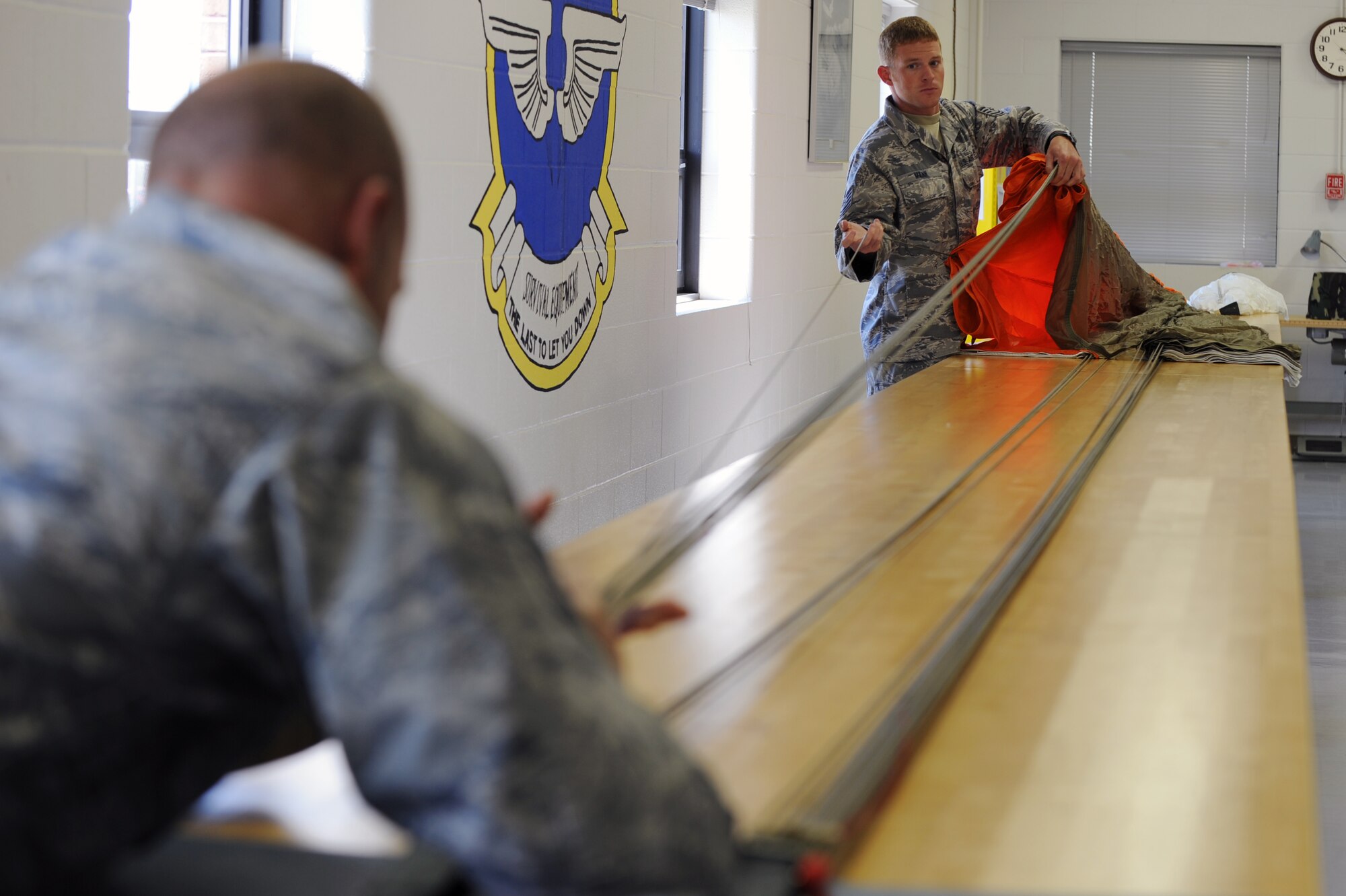 WHITEMAN AIR FORCE BASE, Mo., -- Tech. Sgt. Clinton Dalton 509th Operations Group NCO in charge of quality assurance and Tech. Sgt. Jacob Mann, 110th Bomb Squadron Aircrew Flight Equipment technician, check the BA-22 parachute lines for a T-38. Ensuring the lines match up prevents the chute from partial release.
(U.S. Air Force photo/Staff Sgt. Jason Huddleston) (Released)

