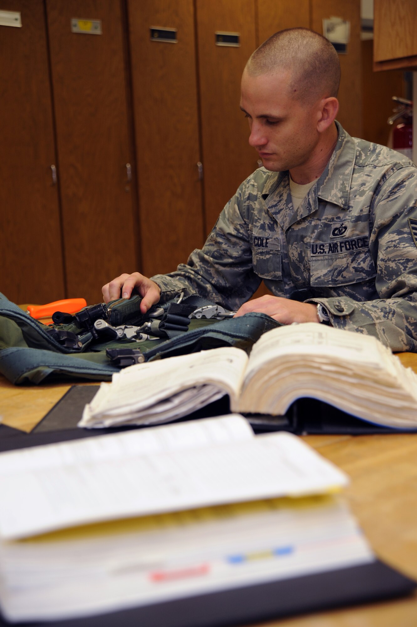 WHITEMAN AIR FORCE BASE, Mo., -- Tech. Sgt. Michael Cole, 393rd Aircrew Fight Equipment NCO in charge, uses his technical order to inspect the torso harness used in the B-2 ejection seat. The TO gives step-by-step procedures on inspecting safety equipment.
(U.S. Air Force photo/Staff Sgt. Jason Huddleston) (Released)


