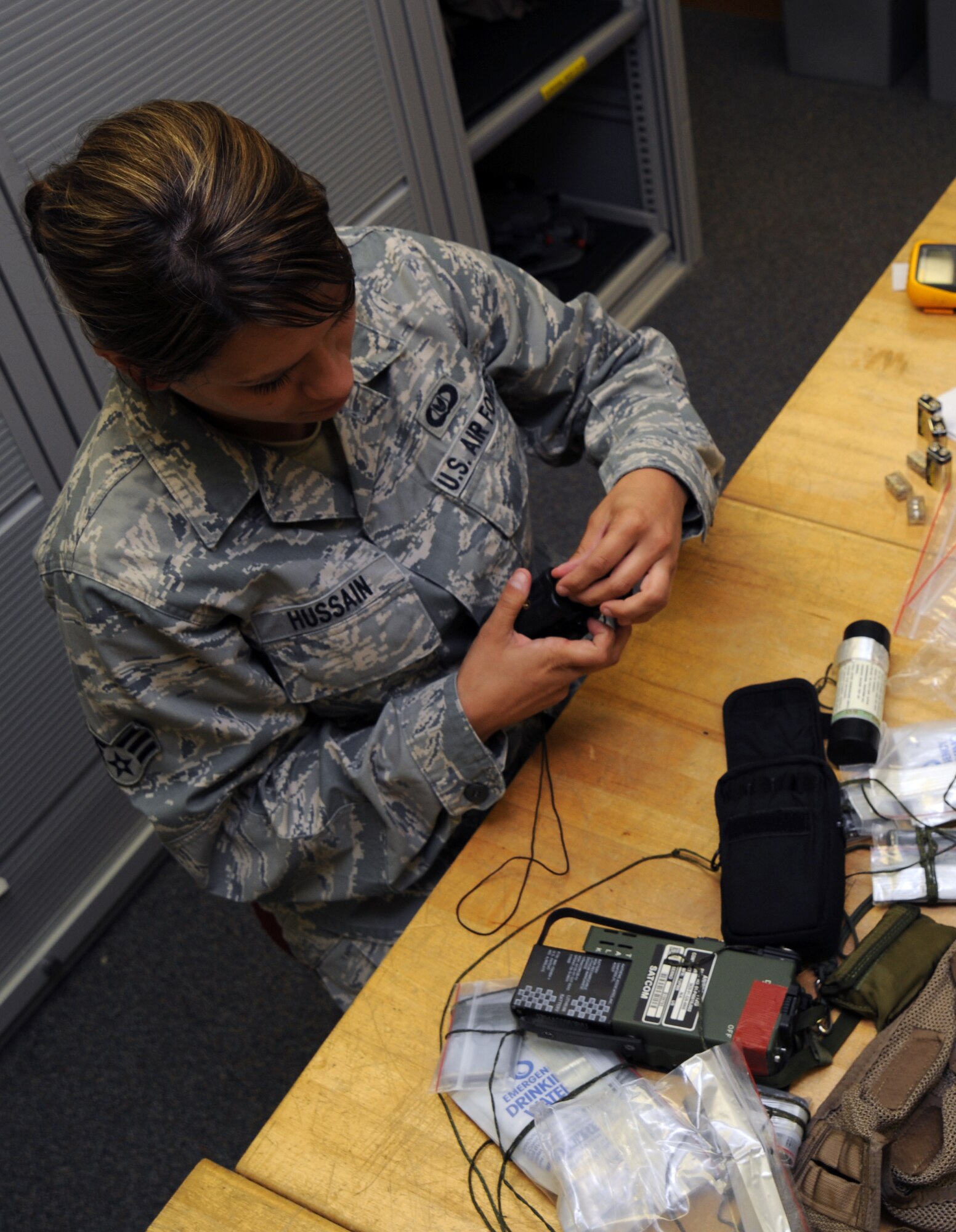 WHITEMAN AIR FORCE BASE, Mo., -- Senior Airman Ashley Hussian 393rd Aircrew Flight Equipment technician, inspects the air advanced concept ejection survival vest. The vest contains a weapon, flare, water, and additional life preserving items. 
(U.S. Air Force photo/Staff Sgt. Jason Huddleston) (Released)

