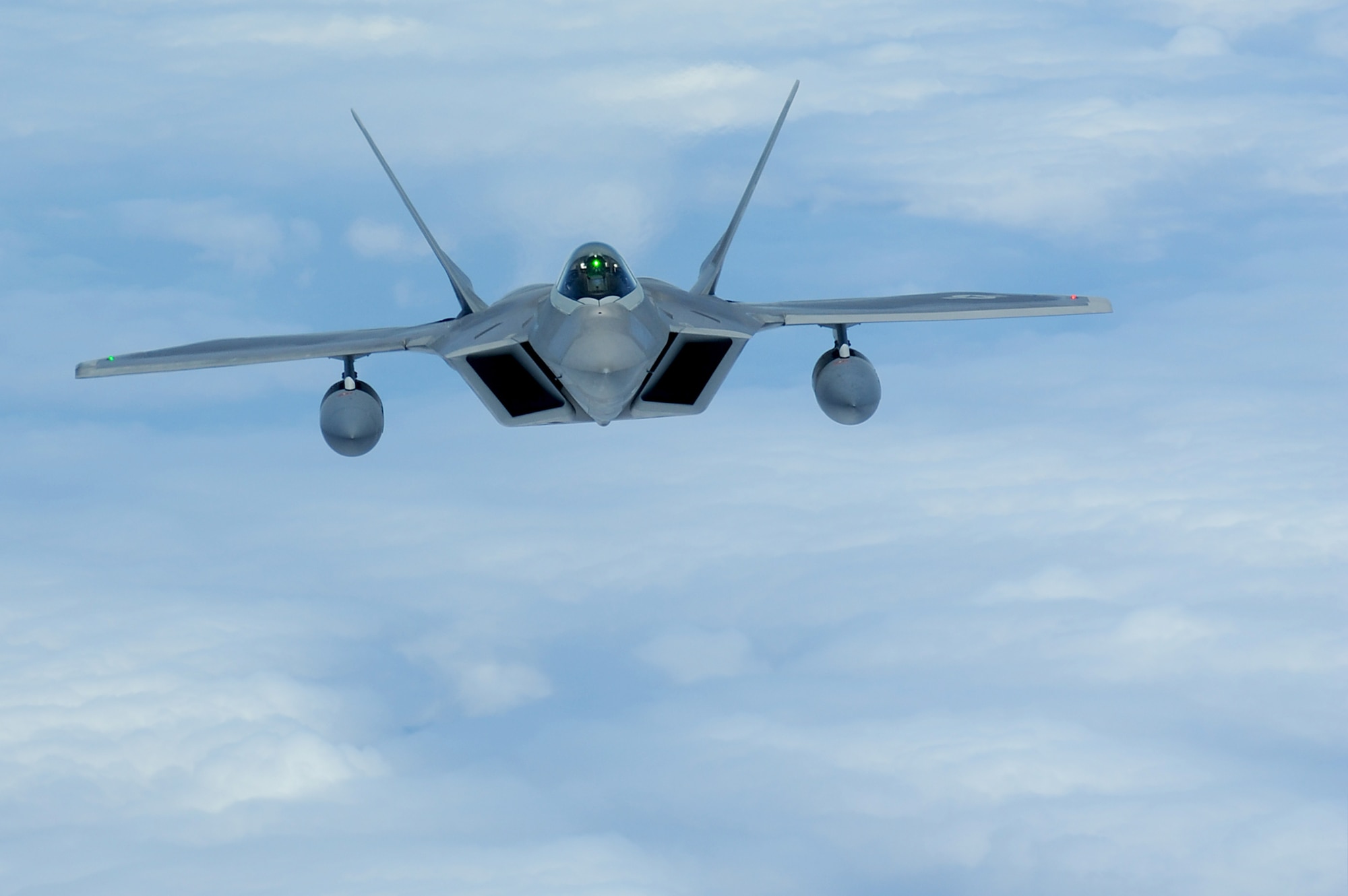 An F-22 Raptor flies over the Pacific Ocean July 2, 2010, on its way to its new home at Joint Base Pearl Harbor-Hickam, Hawaii. (U.S. Air Force photo/Senior Airman Gustavo Gonzalez)