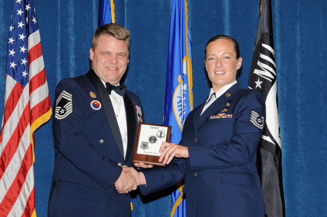 McGHEE TYSON AIR NATIONAL GUARD BASE, Tenn. - Tech. Sgt. Vallaree J. Rudd, right, a member of the Utah Air National Guard, receives the distinguished graduate award for Satellite NCO Academy Class 10-6 at The I.G. Brown Air National Guard Training and Education Center here from Chief Master Sgt. Donald Felch, ANG advisor to the Barnes Center, June 29, 2010.   The distinguished graduate award is presented to students in the top ten percent of the class.  It is based on objective and performance evaluations, demonstrated leadership, and performance as a team player.   (U.S. Air Force photo by Master Sgt. Kurt Skoglund/Released)