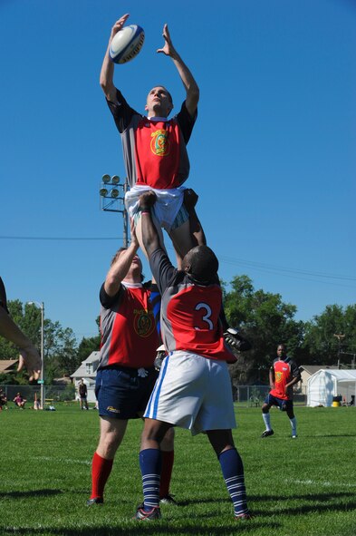 BISMARCK, N.D. -- Dustin Fischer, Minot resident and rugby team member, is lifted into the air by his teammates to restart the game at Hughes School Football Field here July 10. Though the odds didn’t weight in their favor, the Team Minot players came together in a final game with their Bismarck opponents. In the end however, Bismarck topped Minot 26-19. (U.S. Air Force photo by Senior Airman Ashley N. Avecilla)