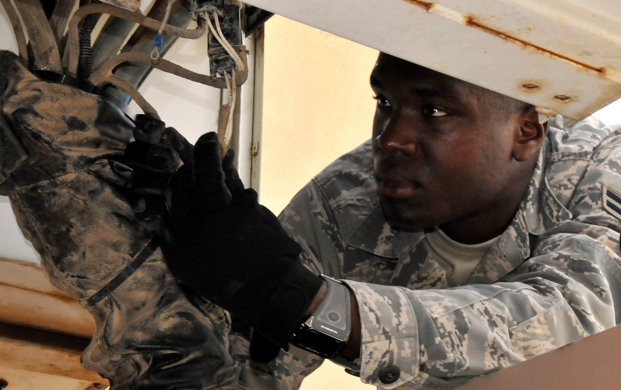 Airman 1st Class David O’Loughlin, 521st Air Mobility Operations Group, Detachment 5 crew chief, inspects a wire harness of a U30 aircraft tow vehicle July 12, 2010, Joint base Balad, Iraq. The U30 tow vehicle weighs approximately 100,000 pounds, making it ideal for pushing and pulling heavy aircraft like the C-17 Globemaster III. Airman O’Loughlin, a native of Oakland, Calif., deployed from Joint Base McGuire-Dix-Lakehurst, N.J. (U.S. Air Force photo/Staff Sgt. Phillip Butterfield)