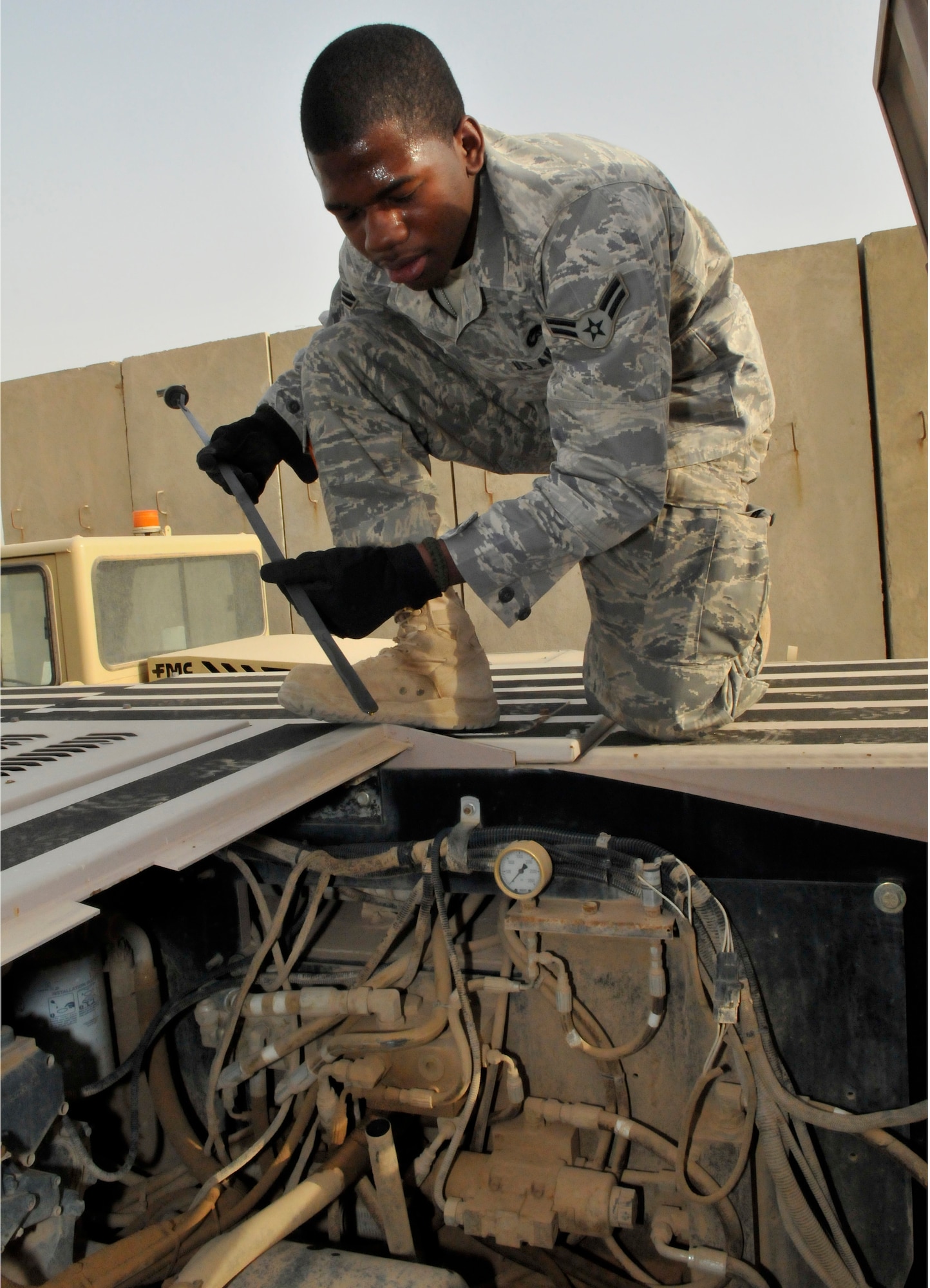 Airman 1st Class Christopher Atkins, 521st Air Mobility Operations Group, Detachment 5 aerospace propulsion specialist, checks the oil level on a U30 aircraft tow vehicle July 12, 2010, Joint base Balad, Iraq. The U30 tow vehicle is used to maneuver aircraft for maintenance. Airman Atkins, a native of Fayetteville, N.C., deployed from Joint Base McGuire-Dix-Lakehurst, N.J. (U.S. Air Force photo/Staff Sgt. Phillip Butterfield)