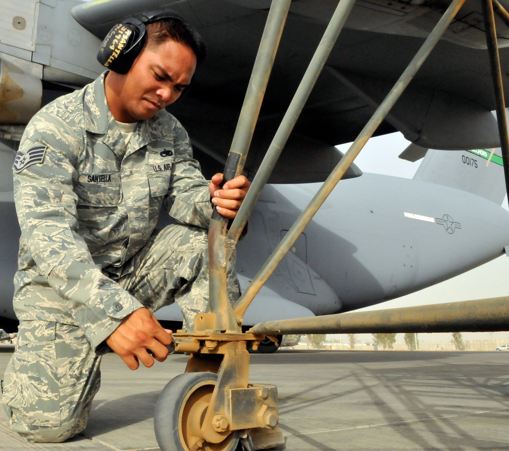 Staff Sgt. Ryan Santella, 521st Air Mobility Operations Group, Detachment 5 hydraulics journeyman, locks a caster wheel of a B5 maintenance stand into place July 12, 2010, Joint base Balad, Iraq. The B5 Maintenance stand is the preferred stand for reaching high access panels on the C-17 Globemaster III. Sergeant Santella, a native of Honolulu, deployed from Joint Base McGuire-Dix-Lakehurst, N.J. (U.S. Air Force photo/Staff Sgt. Phillip Butterfield)