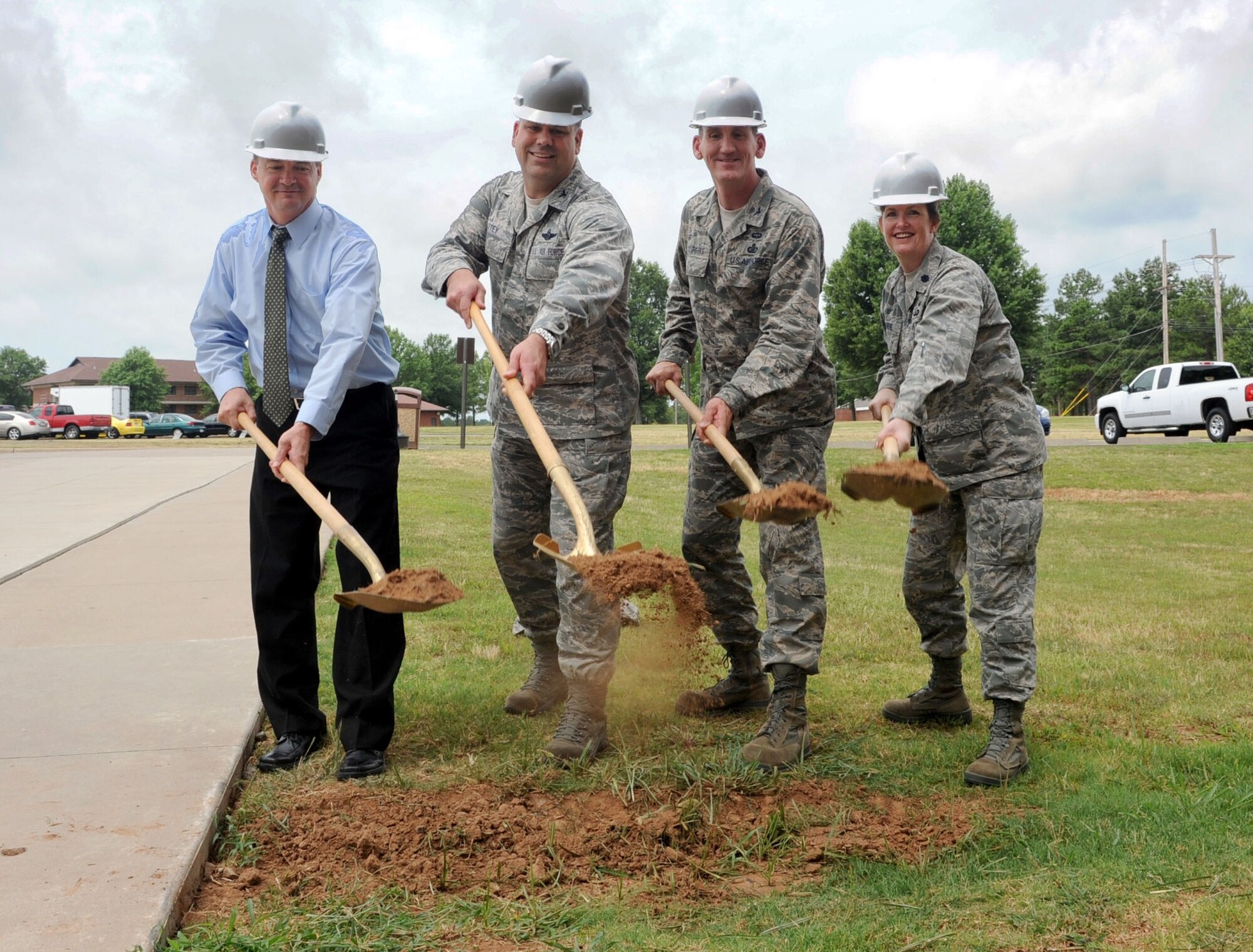 (From left) Tim Perkins, 19th Force Support Squadron fitness center director; Col. Greg Otey, 19th Airlift Wing commander; Col. George Coggins, 19th Mission Support Group commander; and Lt. Col. Debbie Horne, 19th FSS commander; break ground July 8 during a ceremonial groundbreaking at the fitness center. The ceremony kicked off renovations to be done to the fitness center and sidewalks across the base. (U.S. Air Force photo by Senior Airman Ethan Morgan)