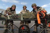 WHITEMAN AIR FORCE BASE, Mo. - 442nd Fighter Wing Airmen, work to save a "battle victim" who has lost an arm and is going into shock. Throughout the Conventional Operational Readiness Inspection, Airmen displayed their technical skills to ensure career proficiency(U.S. Air Force photo/ Senior Airman Carlin Leslie)(Released)
