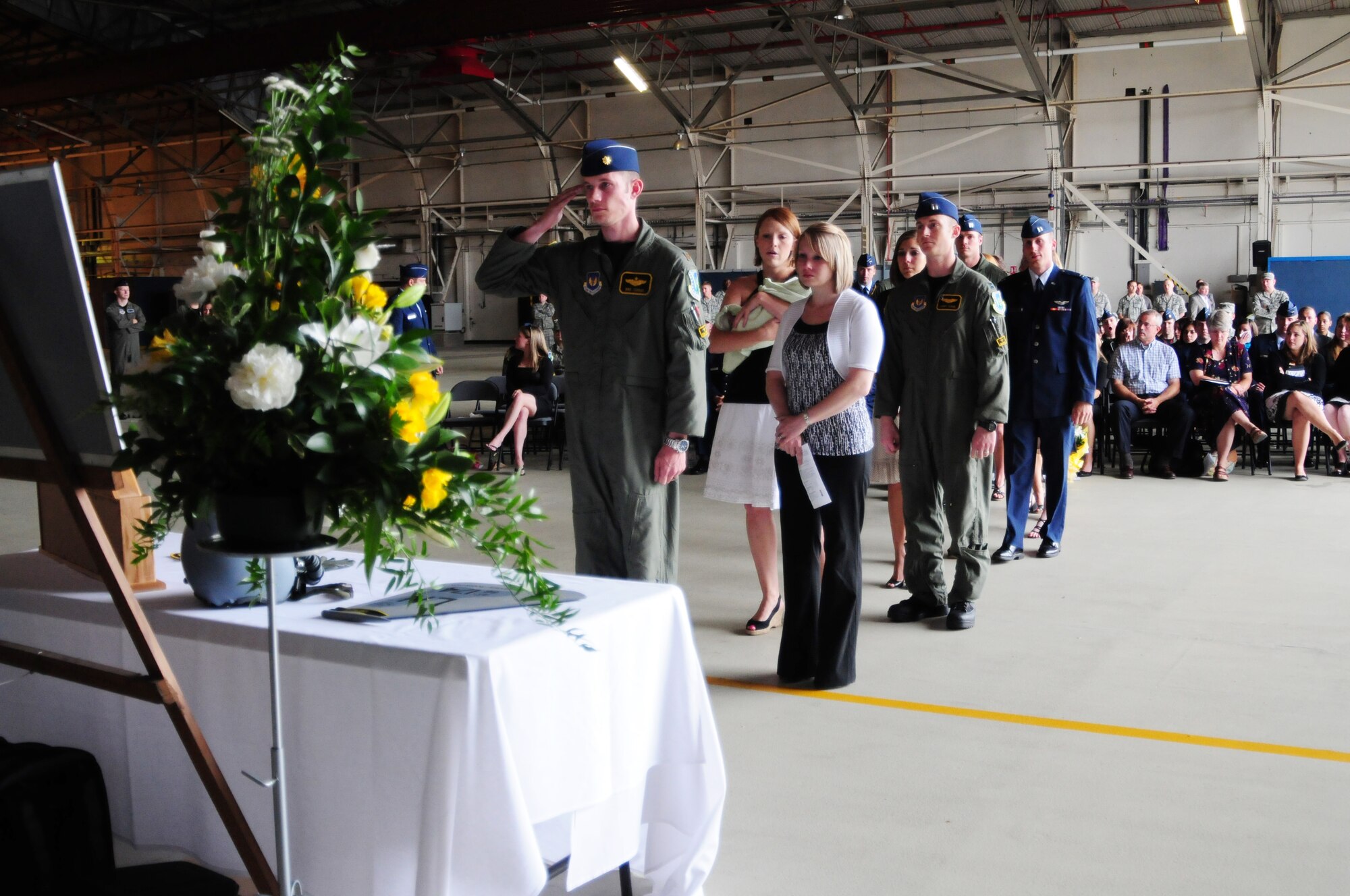 Members of the 48th Fighter Wing pay their final respects to Capt. Samuel Robertson July 13 in Hangar 7 on RAF Lakenheath, England. More than 100 Airmen and family members came to remember Captain Robertson, who passed away July 7. (U.S. Air Force photo/Airman 1st Class Lausanne Morgan)