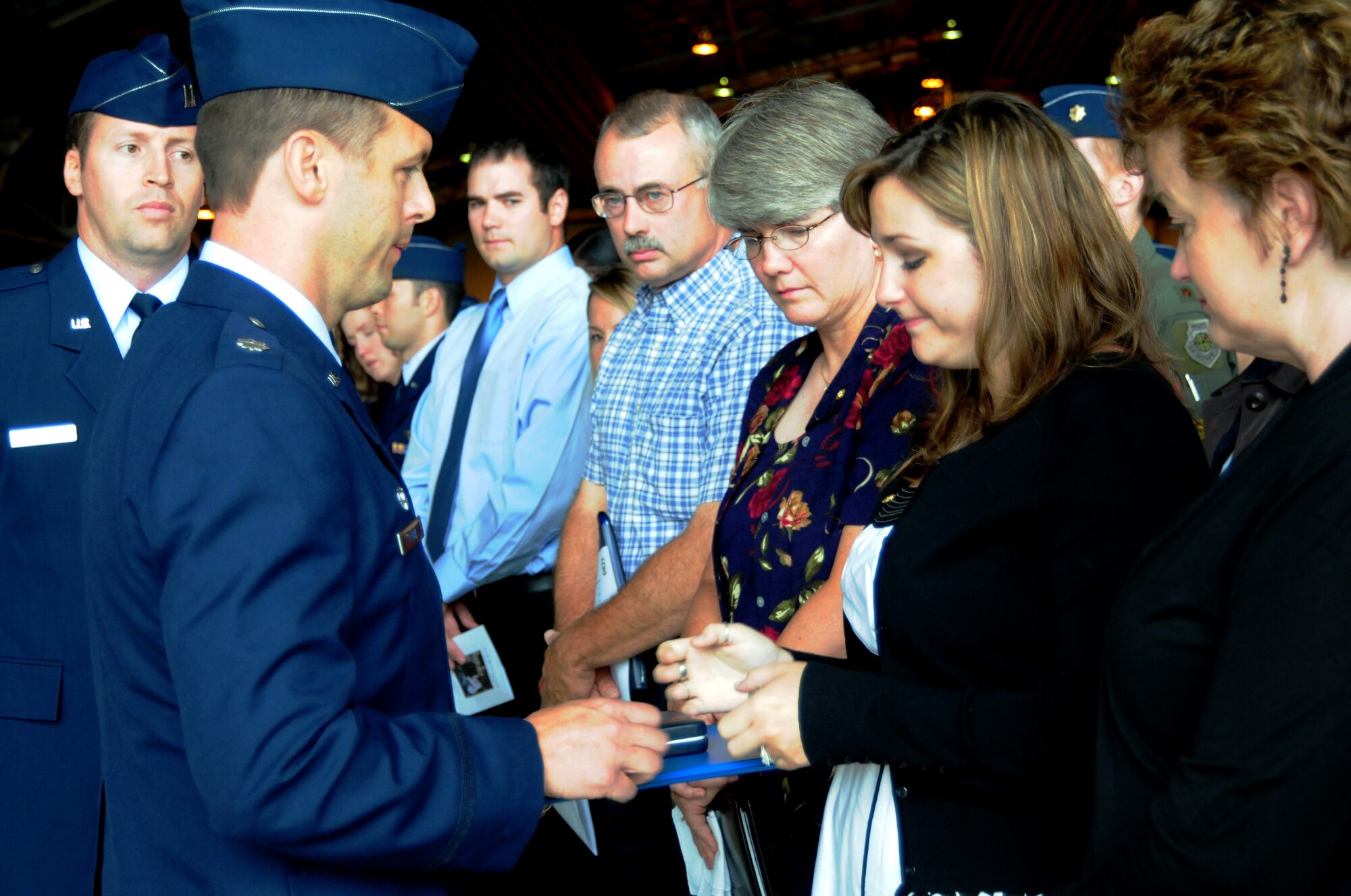 Lt. Col. Skip Pribyl, 493rd Fighter Squadron commander, presents the Air Force Commendation Medal to Jennifer Robertson, the widow of Capt. Samuel Robertson, at a memorial service July 13 in Hangar 7 on RAF Lakenheath, England. Captain Robertson, who suddenly passed away July 7, was posthumously awarded the medal for his service to the 493rd FS. (U.S. Air Force photo/Airman 1st Class Lausanne Morgan)
