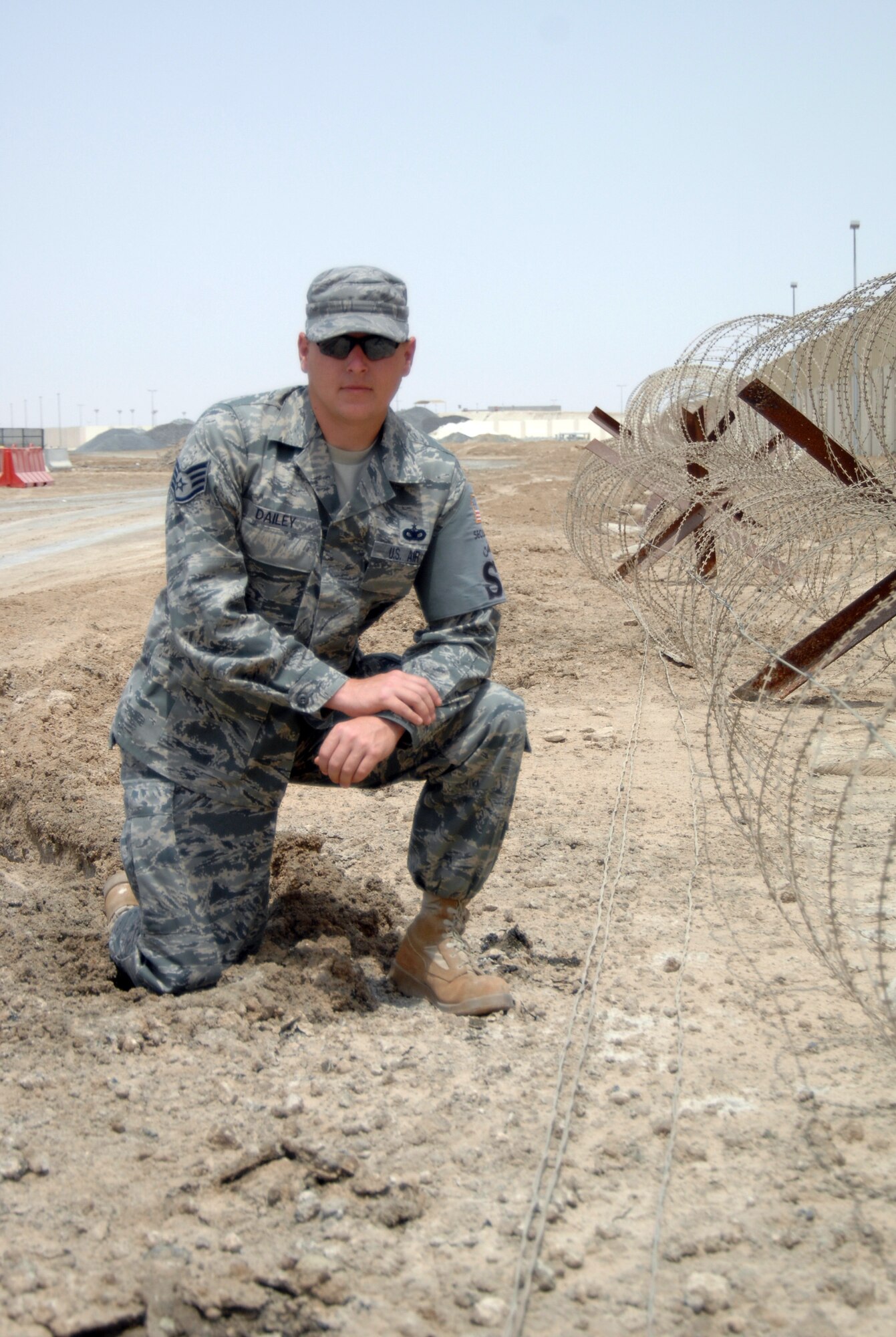 Staff Sgt. Tommy Dailey, security forces craftsman with the 380th Expeditionary Security Forces Squadron, poses near the perimeter of this nondisclosed base in Southwest Asia on July 14, 2010. (U.S. Air Force Photo/Staff Sgt. Jeremy Larlee/released)