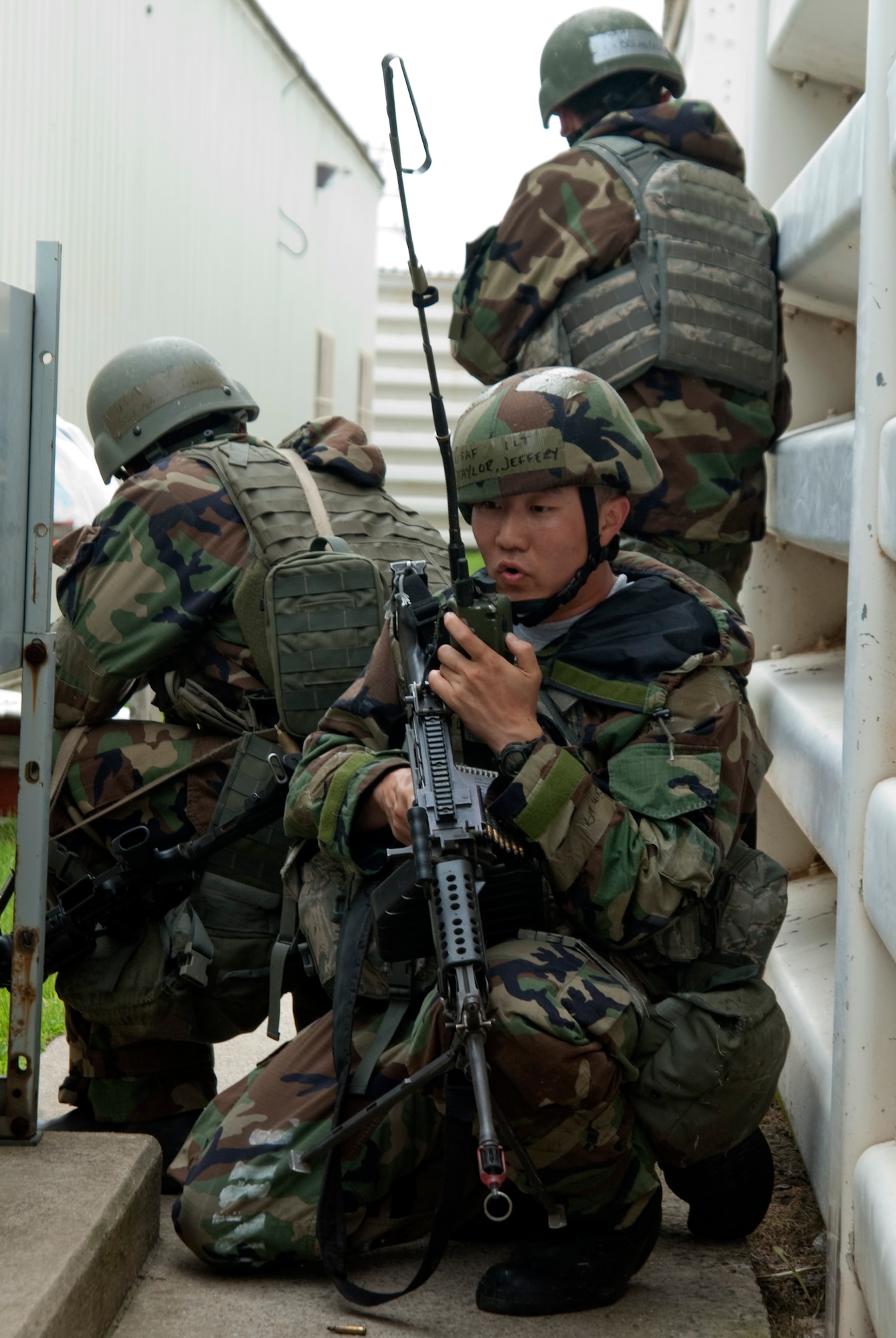 KUNSAN AIR BASE, Republic of Korea –1st Lt. Jeffery Taylor, 8th Security Forces Squadron flight commander, radios in vital information after responding to a ground assault at the 8th Communications Squadron compound as two other defenders keep watch while participating in exercise Beverly Bulldog 10-2 July 14.  The ground attack was meant to test the readiness and operational awareness of security forces personnel and augmentees. (U.S. Air Force photo/Staff Sgt. Jonathan Pomeroy)