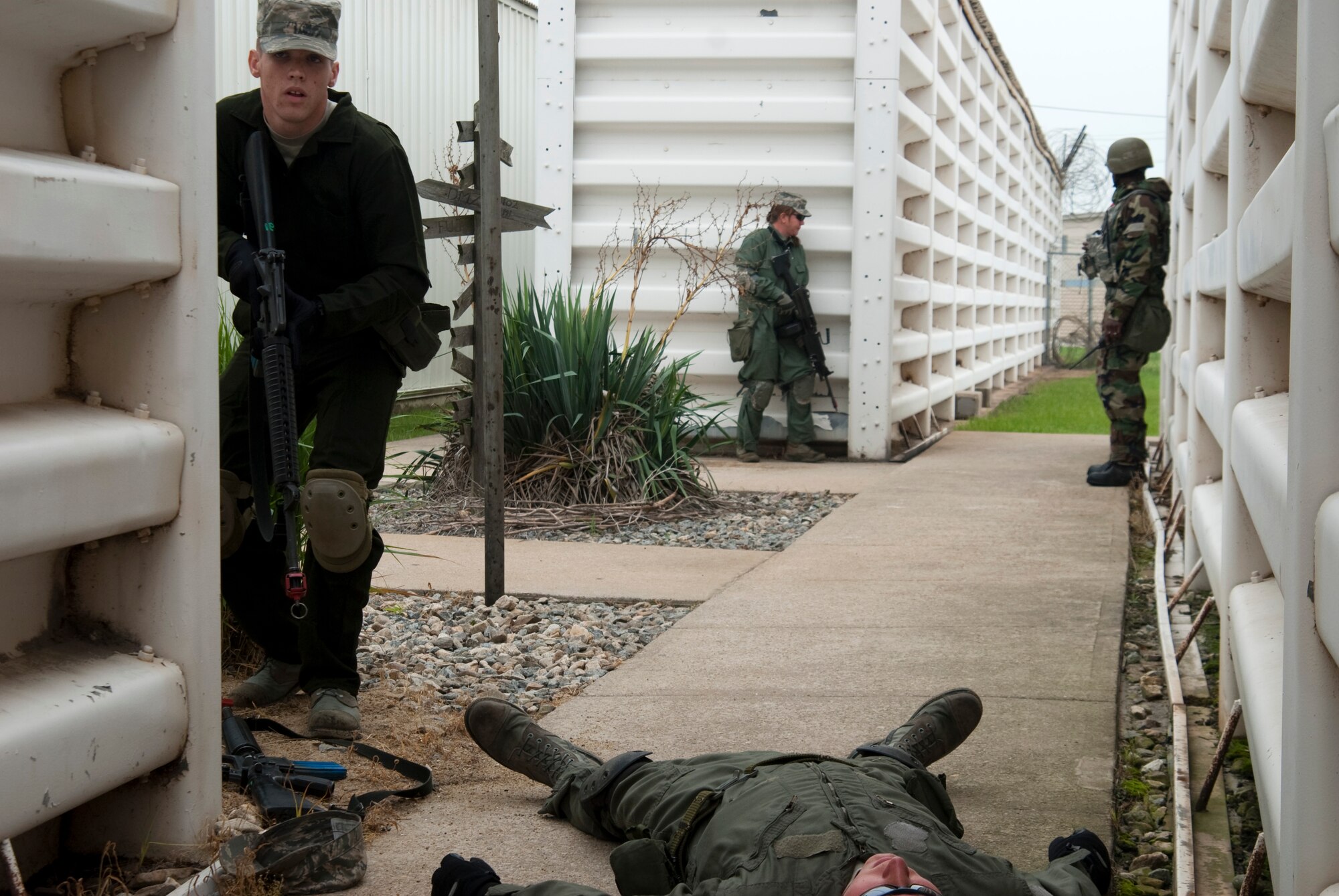 KUNSAN AIR BASE, Republic of Korea – Aggressors take cover positions after taking out one defender while assaulting the 8th Communications Squadron compound while participating in a ground attack scenario during exercise Beverly Bulldog 10-2 July 14.  The attack was meant to test the readiness and operational awareness of security forces personnel and augmentees. (U.S. Air Force photo/Staff Sgt. Jonathan Pomeroy)