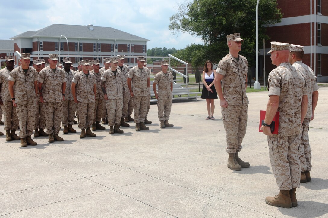 Sgt. William Holls, a combat instructor with Mobile Training Company, Advanced Infantry Training Battalion, School of Infantry – East, is presented the Navy and Marine Corps Medal during a ceremony held aboard Camp Geiger, July 15, for saving a Marine’s life while conducting training in the grenade pit in September 2009.