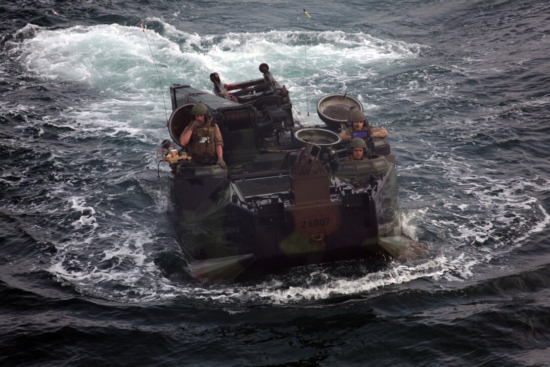 Marines with Company A, 2nd Assault Amphibian Battalion fight the waves of the Atlantic Ocean as they maneuver to the USS Iwo Jima, July 15, to embark for deployment. 2nd AAV Bn. is the ground combat element for the Special-Purpose Marine Air-Ground Task Force Continuing Promise 2010. ::r::::n::
