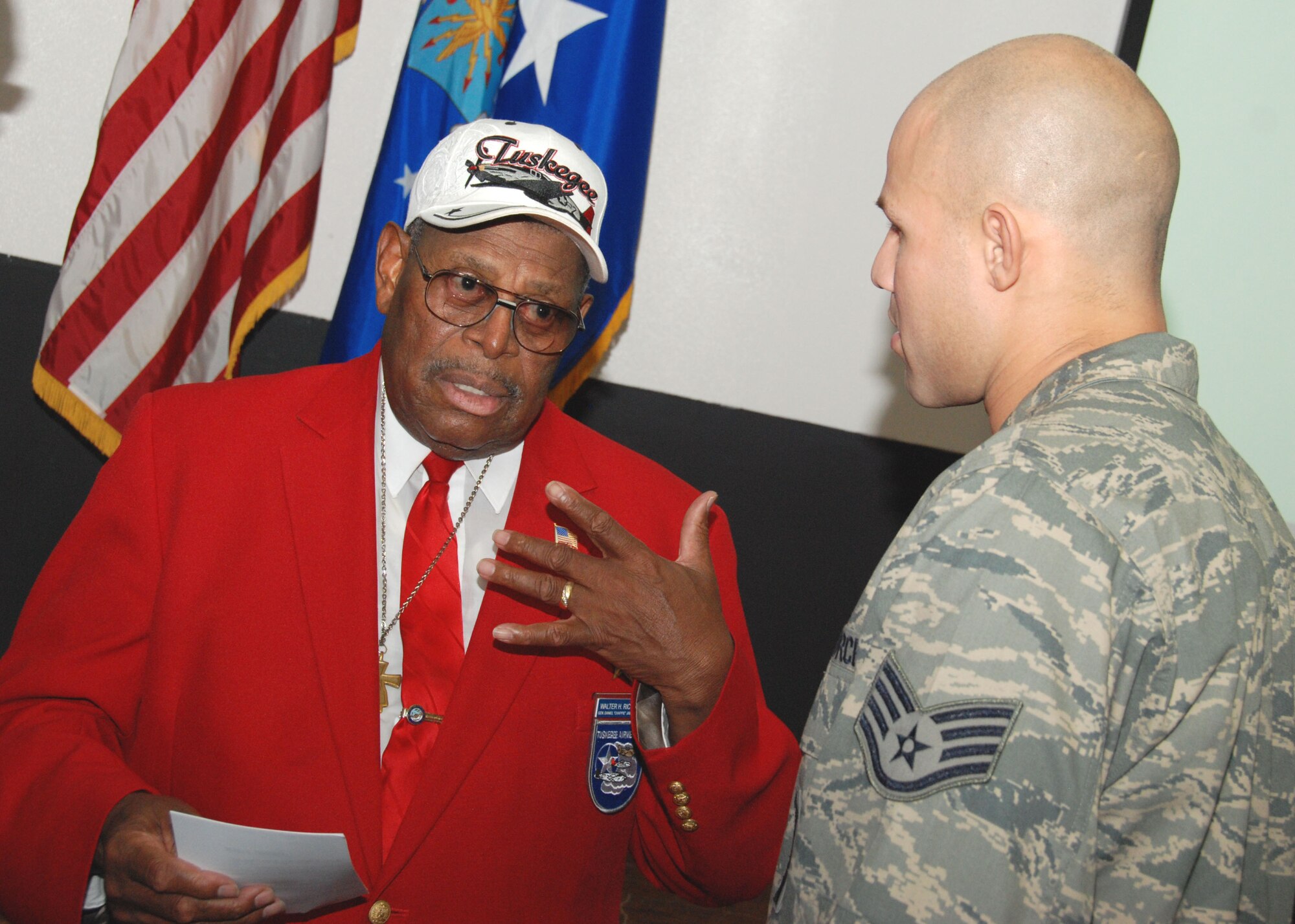 Retired Chief Master Sgt. Walter Richardson is welcomed by a Duke Field reservist inside the base theater July 10. An original member of the famed World War II-era Tuskegee Airmen, the 30-year veteran later spoke to a mass audience of 919th Special Operations Wing reservists about his role as one of the first African-American Airmen tasked to begin integrating the fledgling U.S. Air Force.   (U.S. Air Force photo/Tech. Sgt. Cheryl Foster)
