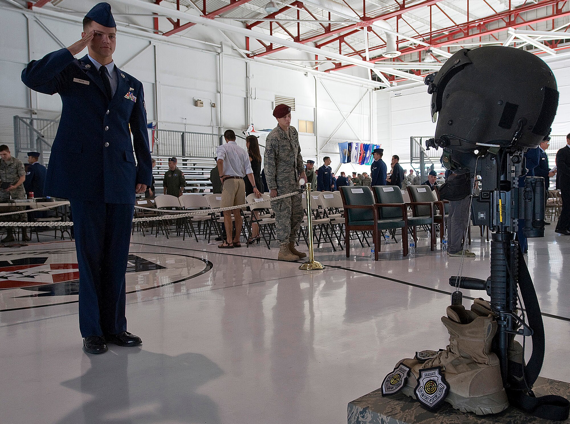 NELLIS AIR FORCE BASE, Nev. -- Senior Airman Kevin Rizer, an aerial gunner assigned to the 66th Rescue Squadron, renders a final salute fellow squadron member, HH-60G helicopter pilot Capt. David Wisniewski during a memorial service at Nellis Air Force Base July 15. Captain Wisniewski, 31, passed away at the National Naval Medical Center in Bethesda, Md., July 2 from injuries received when an HH-60G Pave Hawk helicopter crashed in southeastern Afghanistan June 9. Four other Airmen killed and two others were wounded during the incident. (U.S. Air Force Photo by Airman 1st Class Brett Clashman)
