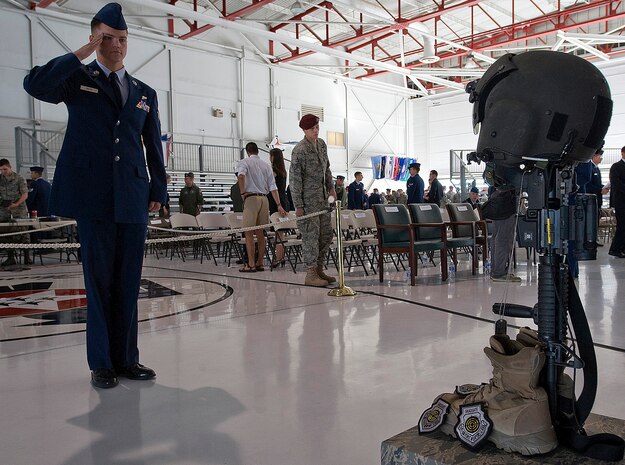 NELLIS AIR FORCE BASE, Nev. -- Senior Airman Kevin Rizer, an aerial gunner assigned to the 66th Rescue Squadron, renders a final salute fellow squadron member, HH-60G helicopter pilot Capt. David Wisniewski during a memorial service at Nellis Air Force Base July 15. Captain Wisniewski, 31, passed away at the National Naval Medical Center in Bethesda, Md., July 2 from injuries received when an HH-60G Pave Hawk helicopter crashed in southeastern Afghanistan June 9. Four other Airmen killed and two others were wounded during the incident. (U.S. Air Force Photo by Airman 1st Class Brett Clashman)

