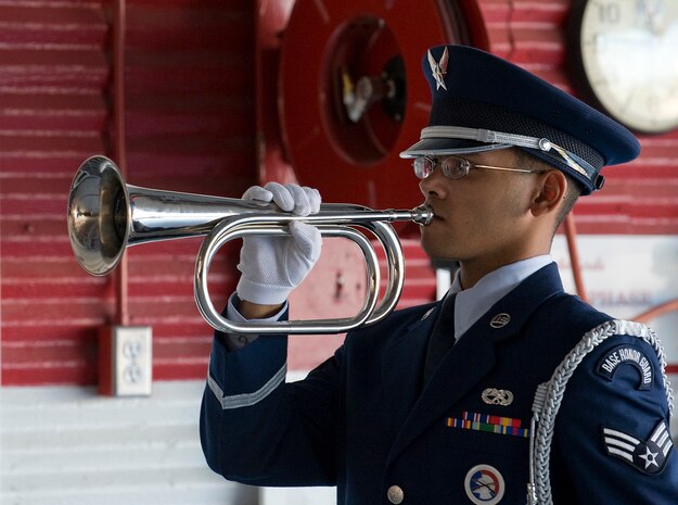 NELLIS AIR FORCE BASE, Nev. --   Senior Airman Aaron Tarver of the Nellis Air Force Base Honor Guard plays the bugle 'Taps" in honor Capt. David Wisniewski, an HH-60G helicopter pilot assigned to the 66th Rescue Squadron, during a memorial service at Nellis Air Force Base July 15. Captain Wisniewski, 31, passed away at the National Naval Medical Center in Bethesda, Md., July 2 from injuries received when an HH-60G Pave Hawk helicopter crashed in southeastern Afghanistan June 9. Four other Airmen killed and two others were wounded during the incident. (U.S. Air Force Photo by Airman 1st Class Brett Clashman)
