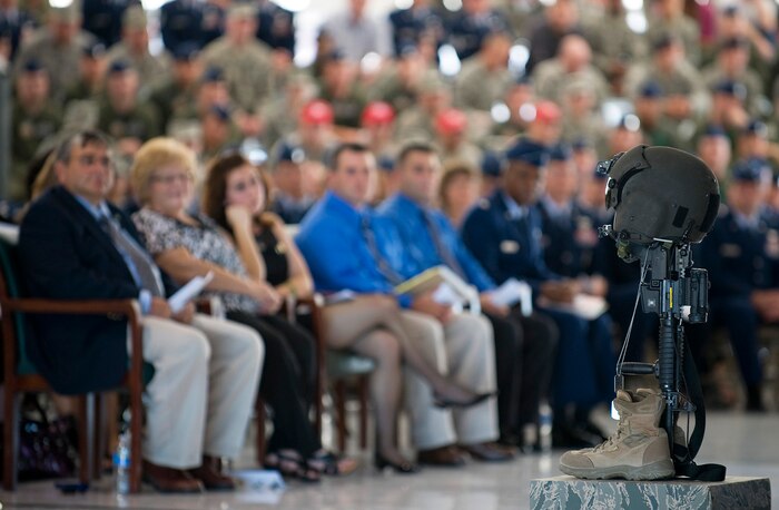 NELLIS AIR FORCE BASE, Nev. --  A battle cross in honor of Capt. David Wisniewski, an HH-60G helicopter pilot assigned to the 66th Rescue Squadron, sits in the foreground during a memorial service at Nellis Air Force Base, Nev., July 15. Captain Wisniewski, 31, passed away at the National Naval Medical Center in Bethesda, Md., July 2 from injuries received when an HH-60G Pave Hawk helicopter crashed in southeastern Afghanistan June 9. Four other Airmen killed and two others were wounded during the incident. (U.S. Air Force Photo by Airman 1st Class Brett Clashman)
