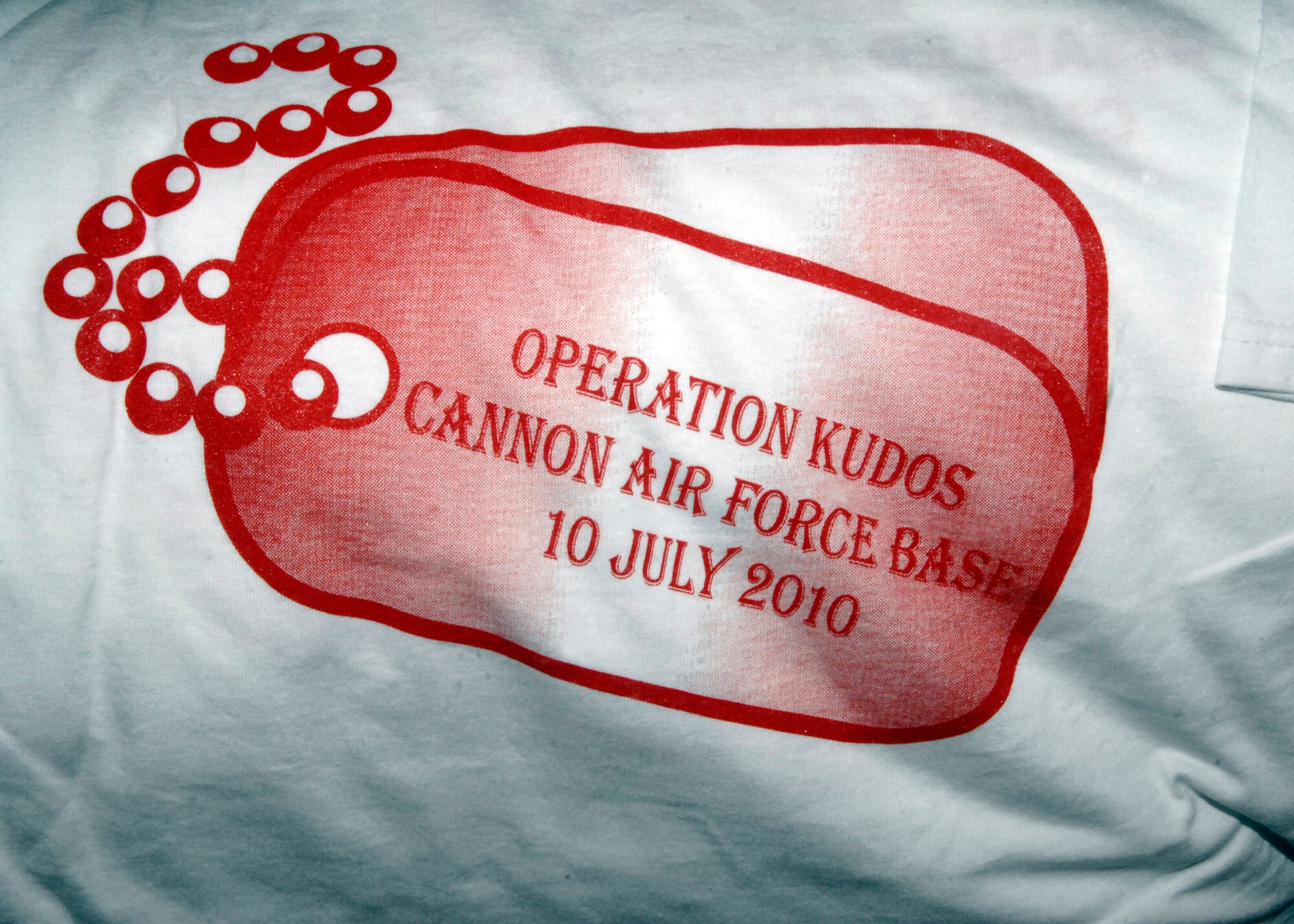 Children receive an Operation KUDOS T-shirt as they prepare to "deploy" June 10, 2010 at Cannon Air Force Base, N.M. KUDOS, or Kids Understanding Deployment Operations, give children a better understanding of what their mother or father go through as Air Commandos of the 27th Special Operations Wing. (U.S. Air Force photo by Greg Allen) (RELEASED)