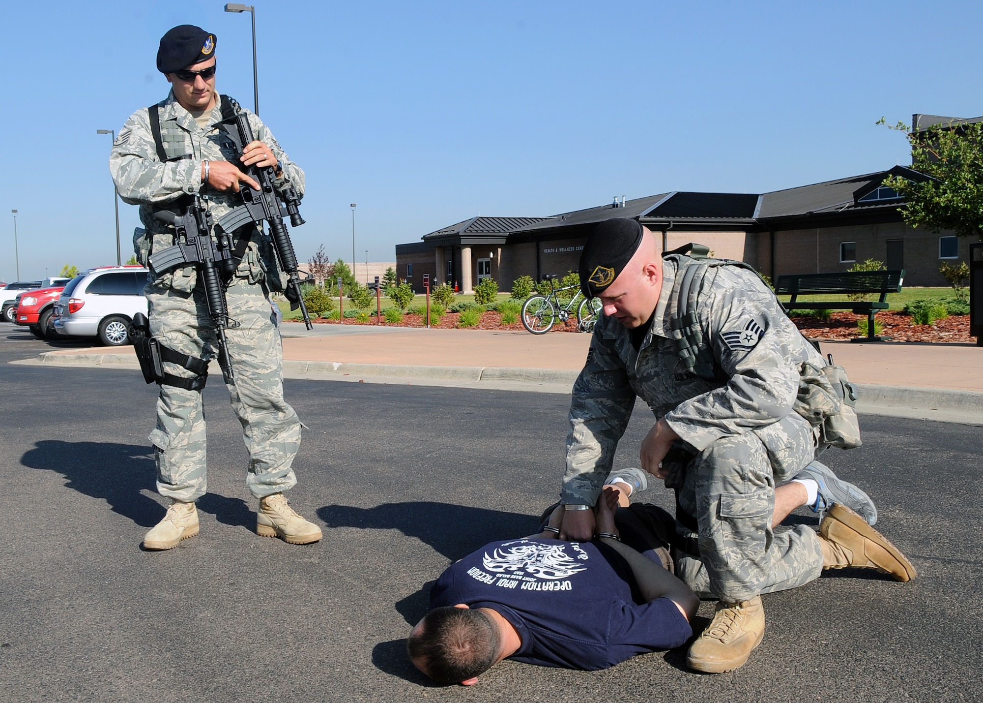 Buckley Air Force Base, Colo.- Buckley's Exercise Evaluation Team gears up testing Buckley's emergency response procedures. Ssgt Christopher Allen and Ssgt Vondor subdue and restrain a robbery suspect at Buckley's Fitness Center.  ( U.S. Air Force Photo by Airman First Class Marcy Glass )
