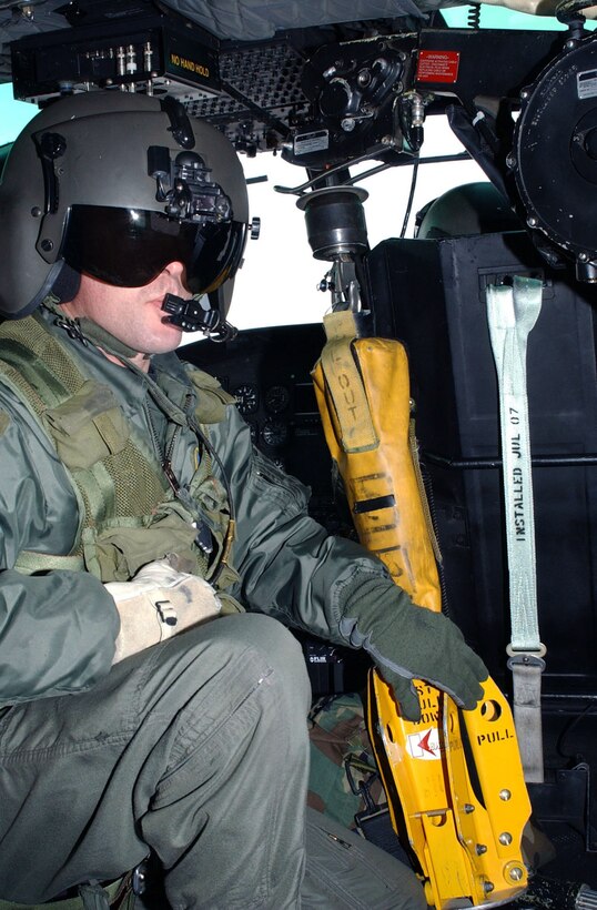 Staff Sgt. Michael Frances  prepares to lower a yellow forest penetrator like the one used to rescue  an injured hiker Juy 2, 2010, near Missoula, Mont. Sergeant Frances is a flight engineer from the 40th Helicopter Squadron. (U.S. Air Force photo/Senior Airman Eydie Sakura)