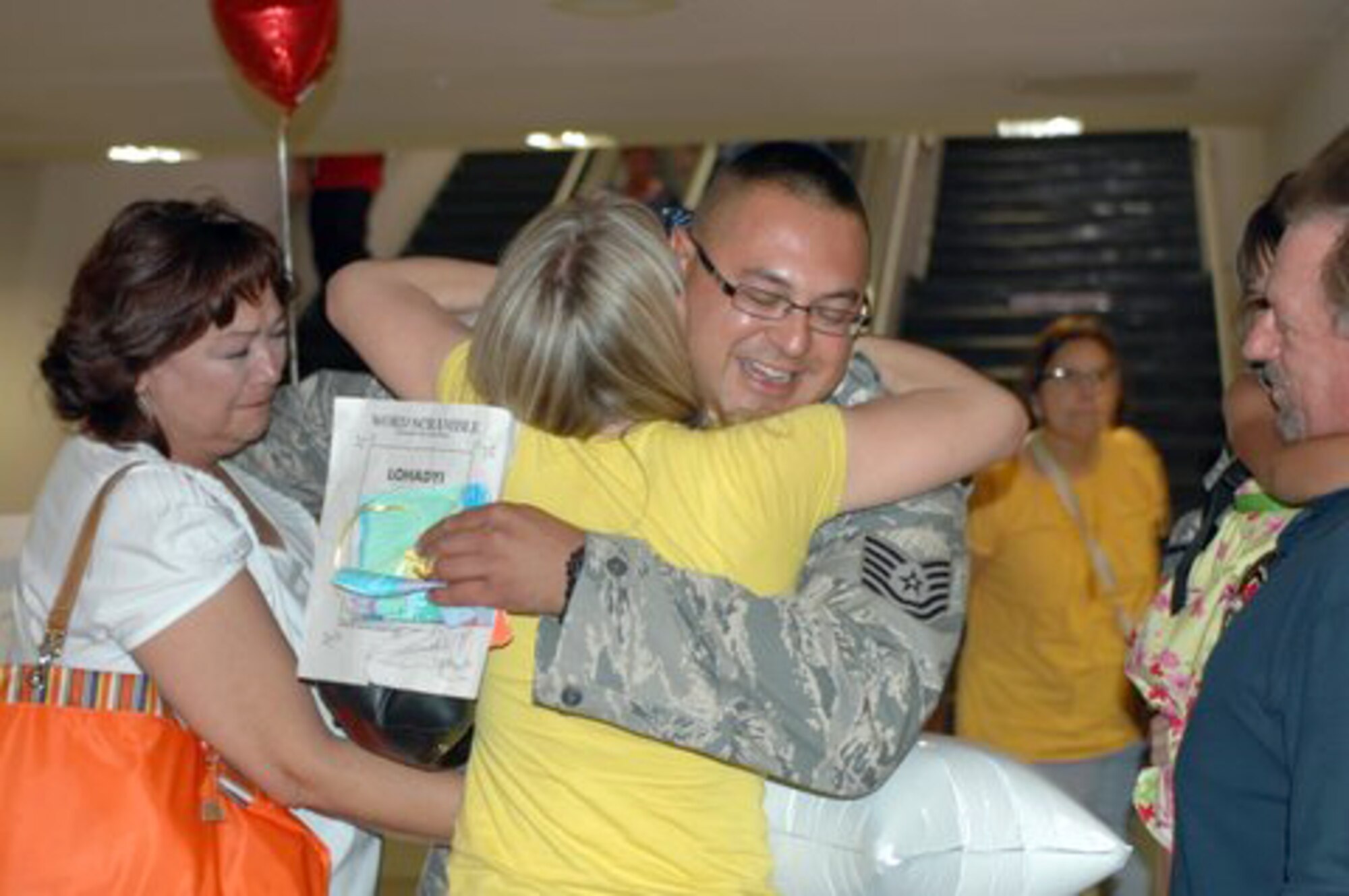 Tech. Sgt. Steve Heimbach, a maintainer with the 162nd Fighter Wing, is welcomed home by family and friends after a deployment to Iraq, July 1.  Wing families will soon benefit from the Yellow Ribbon Reintegration Program which is intended to ease pre-deployment, deployment and post-deployment issues for military families.  (Air Force photo by Barb Gavre)