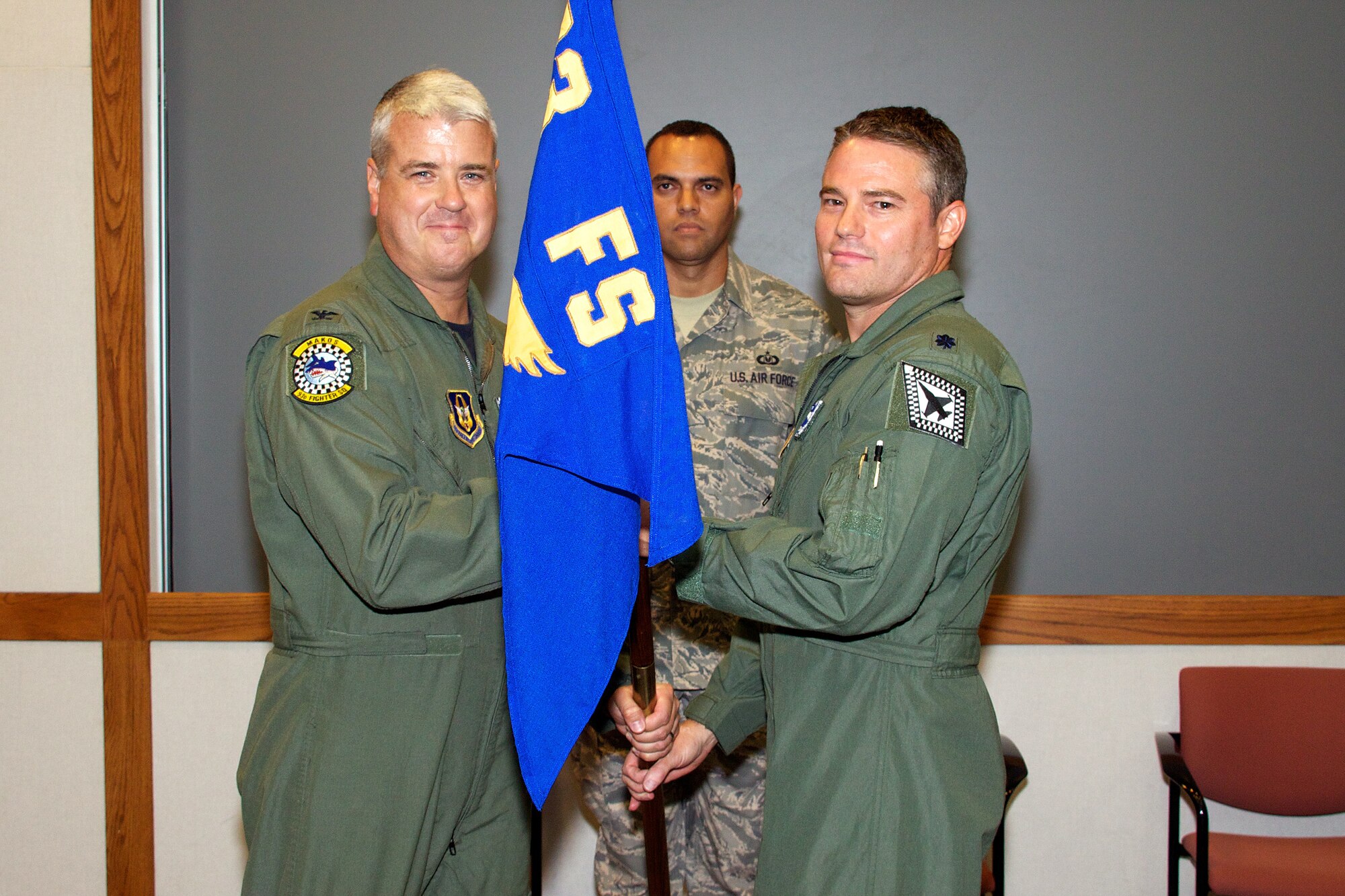 Lt. Col. Michael B. Hohman, right, receives the squadron guidon flag from Col. Ross R. Anderson, 482nd Operations Group commander during a change of command ceremony on July 10.  The 21 year Air Force veteran assumed command of the 93rd Fighter Squadron "Makos" from Lt. Col. David W. Smith. (U.S. Air Force photo/Staff Sgt. Bryan Yale)