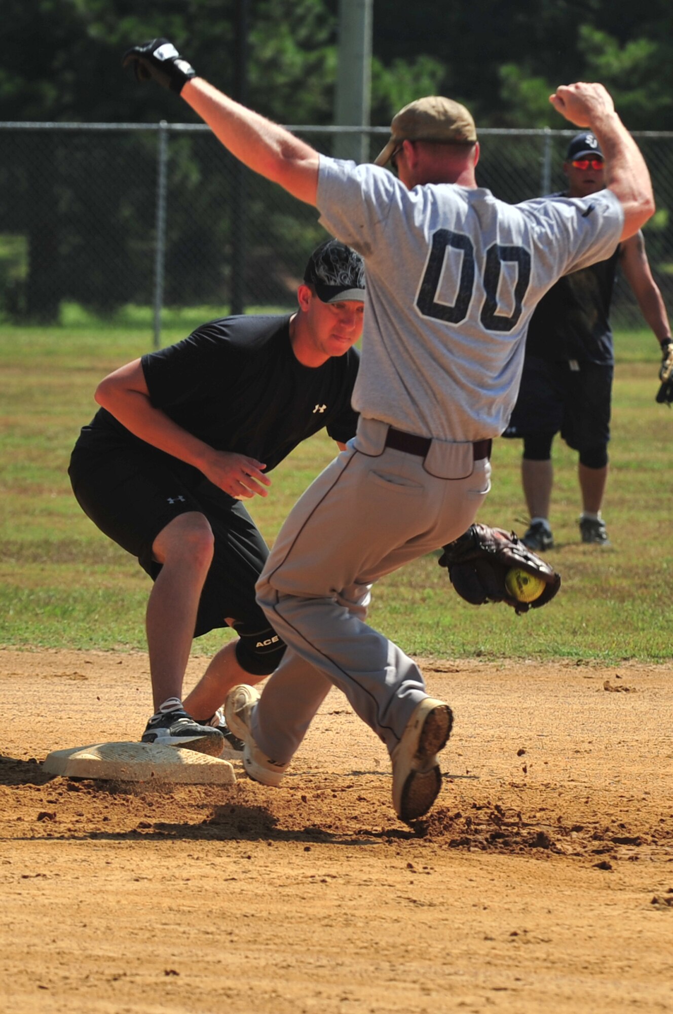 SEYMOUR JOHNSON AIR FORCE BASE, N.C. ? Tyrel Velasquez tags Travis Riccobono out on second base during the Eagles Grand Slam Jamboree Softball Tournament championship game here July 11. Airmen from around the base augmented the USS Truxtun team from Norfolk, Va., during the games because some of their players could not attend. Velasquez, Truxtun second baseman, hails from Amarillo, Texas. Riccobono, Misfits right fielder, is from Dix Hills, N.Y. (U.S. Air Force photo/Senior Airman Rae Perry)