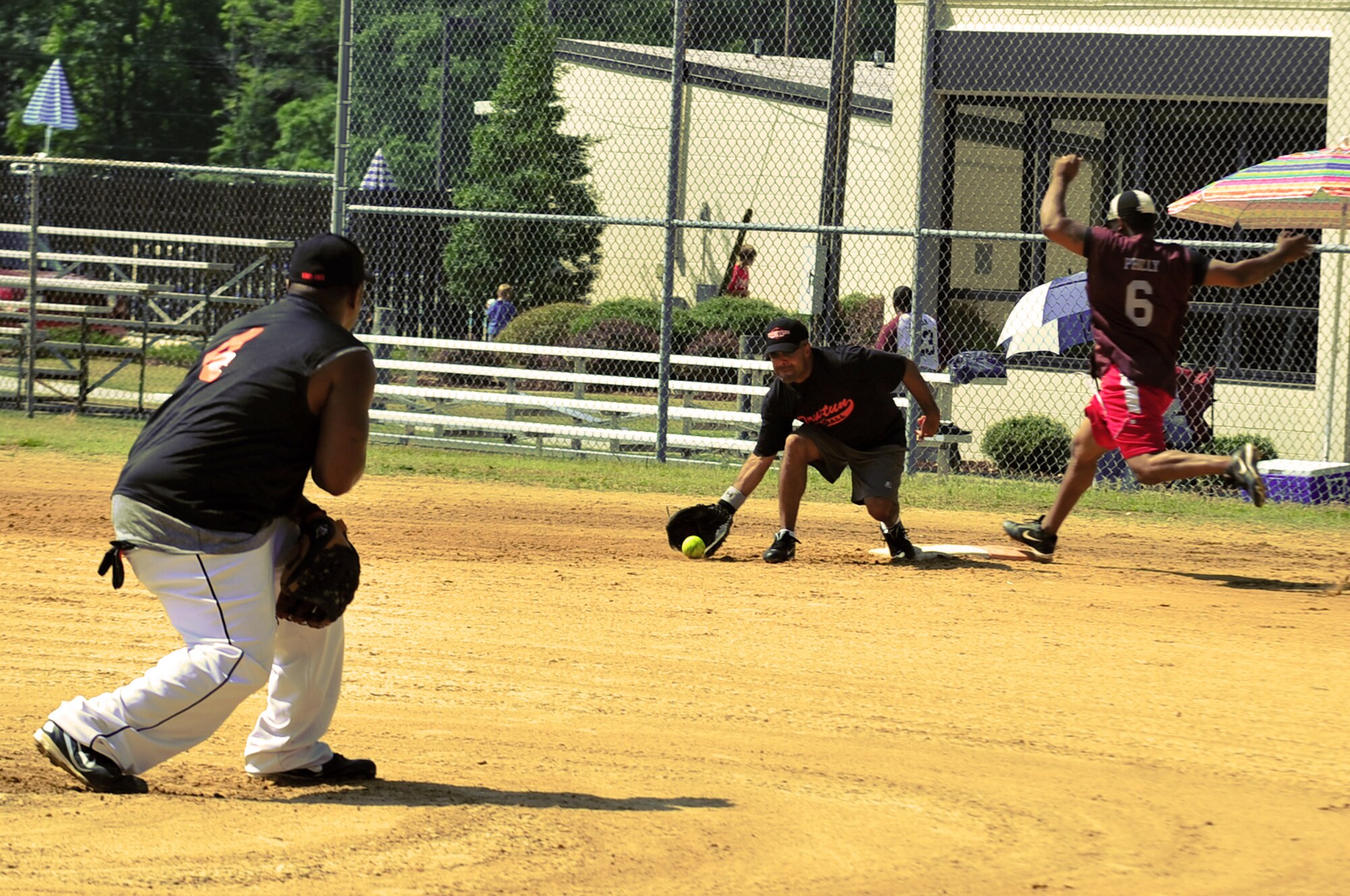 SEYMOUR JOHNSON AIR FORCE BASE, N.C. -- Timothy Jones, Truxtun pitcher, throws the ball to first baseman Jesus Pavon for an out during the Eagles Grand Slam Jamboree Softball Tournament championship game here July 11, 2010. Most military bases have intramural sports. The best teams from those bases will often travel to play other base teams. Jones hails from Gadsden, Ala., and Pavon is from Miami. Both Sailors are stationed on the USS Truxtun based out of Norfolk, Va. (U.S. Air Force photo/Senior Airman Rae Perry)